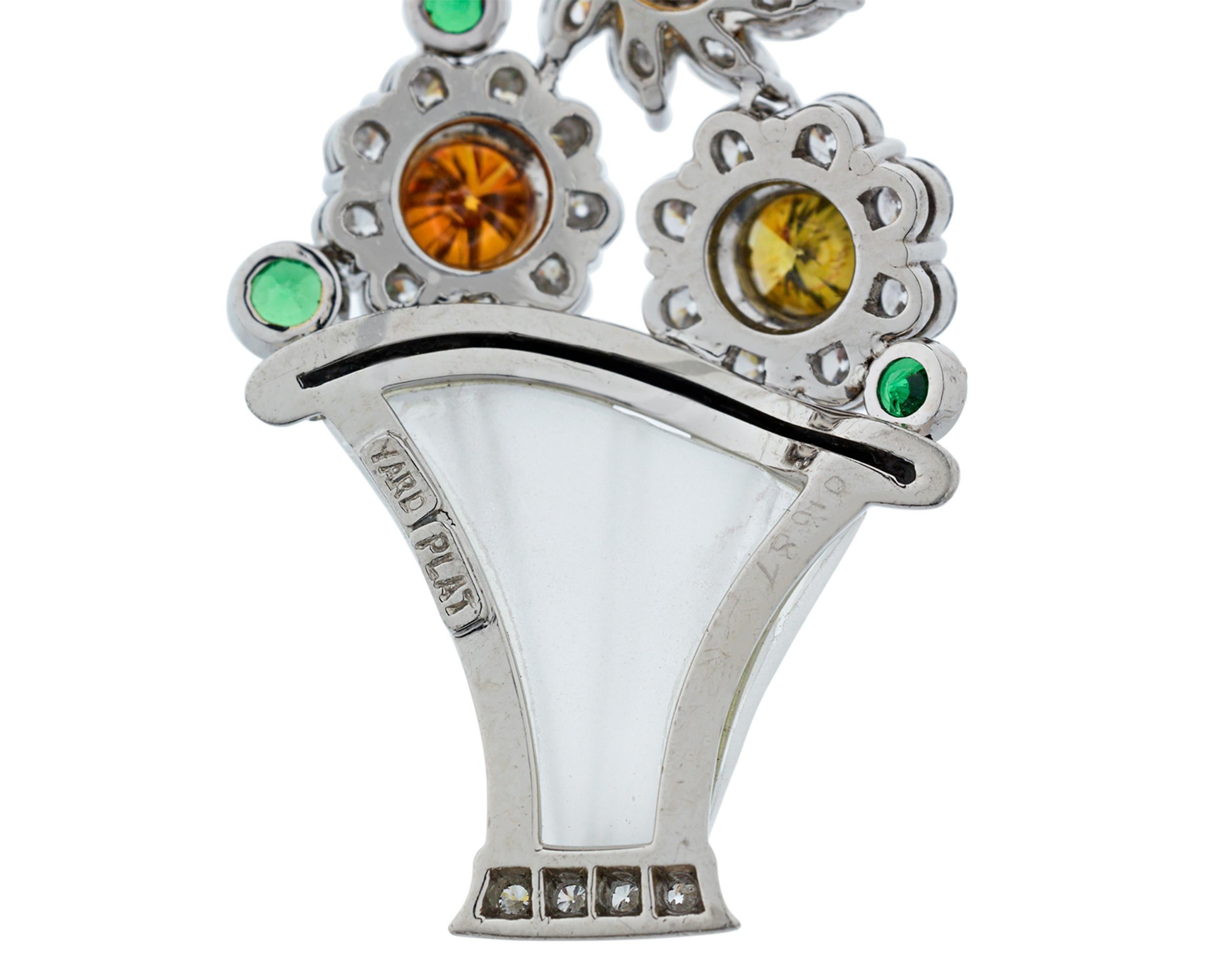 These majestic Raymond Yard earrings feature brilliant springtime baskets of flowers bursting with the dazzling hues of natural fancy colored diamonds. The diamonds display vivid shades of yellow and orange, while bright green tsavorite garnets add