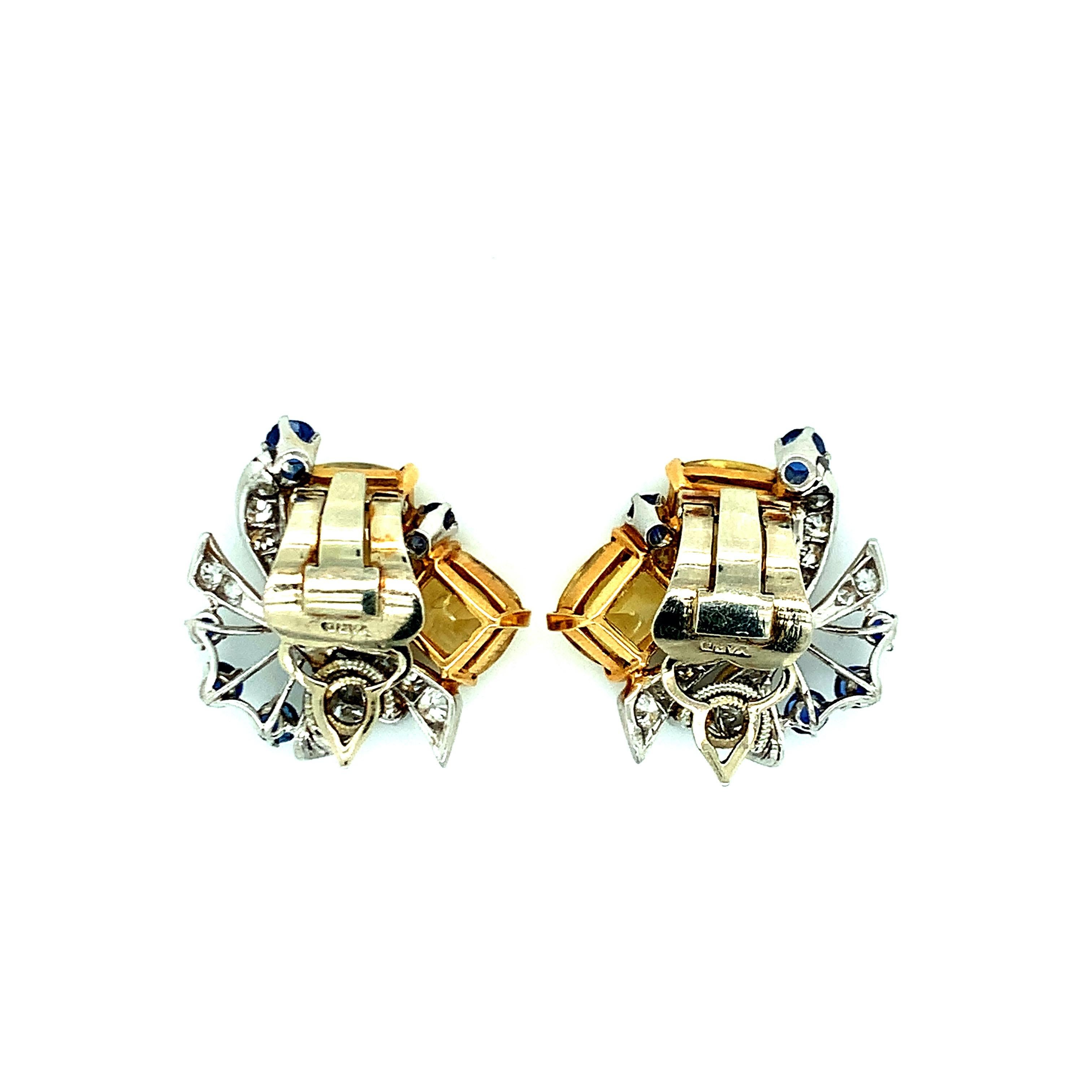 A Raymond Yard pair of platinum, gold, yellow sapphire, sapphire, and diamond ear clips. They consist of four cushion-shaped yellow sapphires approximately 9.75 carats, two round diamonds approximately 0.40 carat, twenty-four round and single-cut