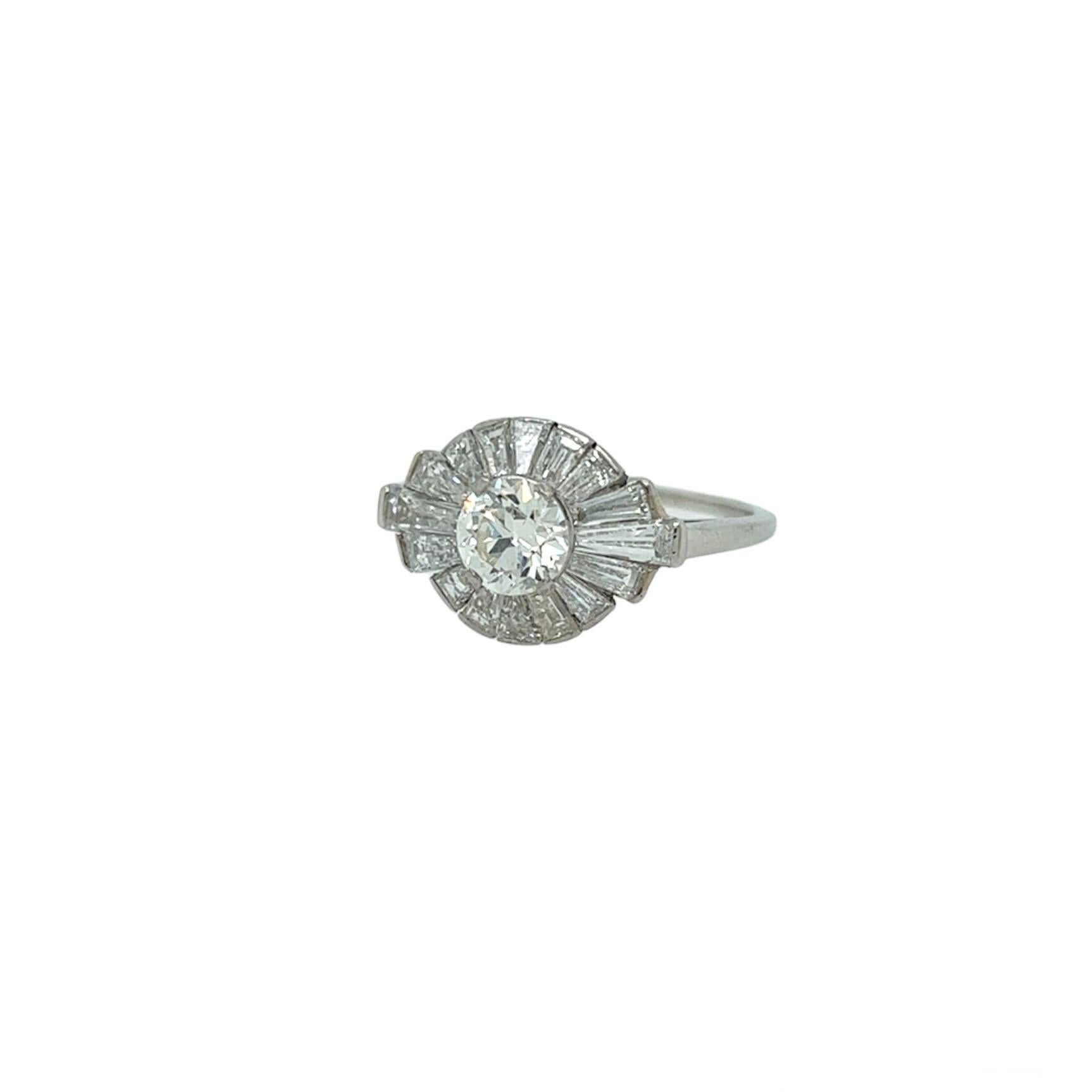 A platinum and diamond ring, Raymond Yard.  Centering a brilliant cut diamond weighing 0.67 carat surrounded by sixteen tapered baguette diamonds in a radiating pattern.  Total diamond weight approximately 2.03 carats.  Size approximately 7 1/2. 