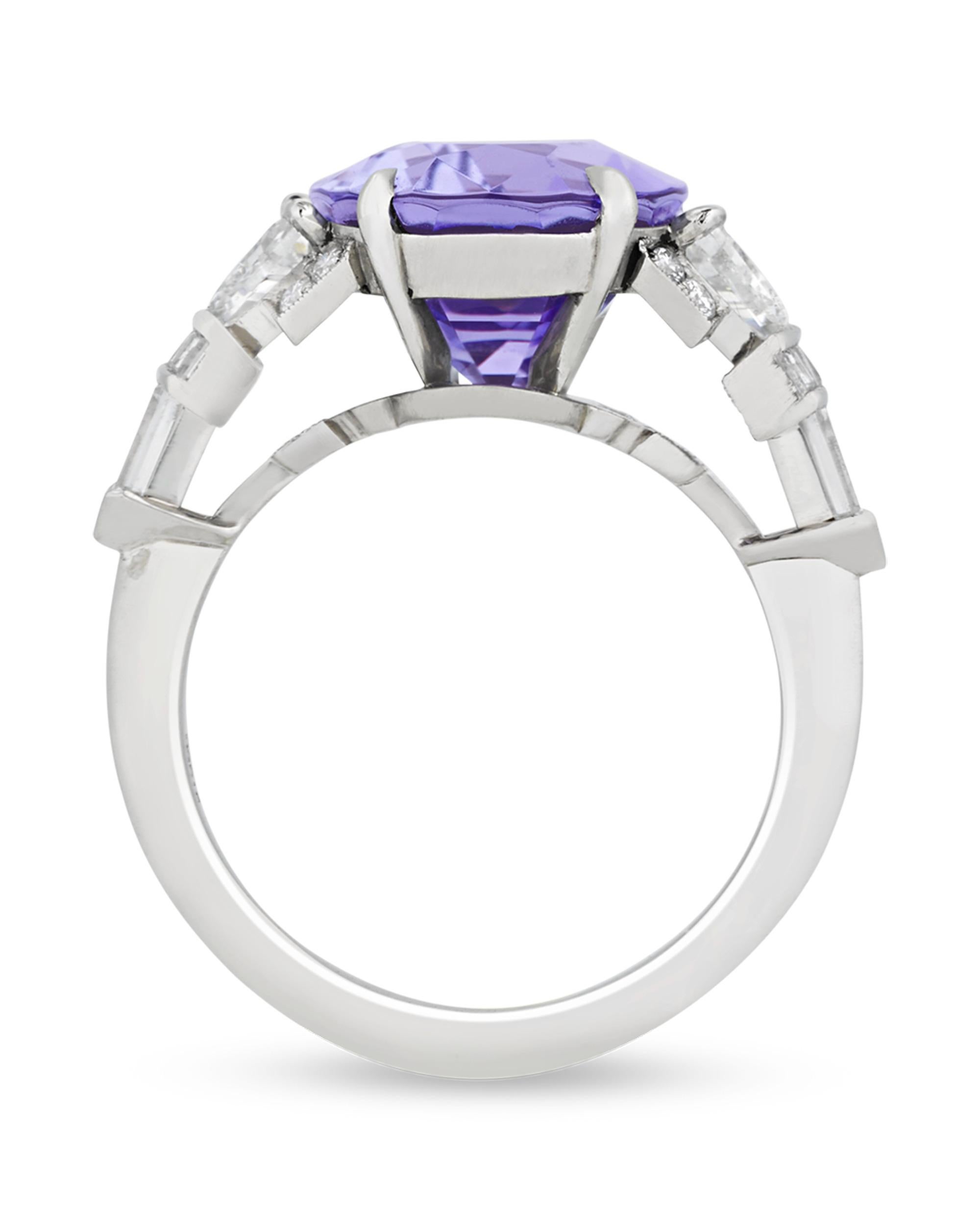 Displaying a remarkable and romantic lavender hue, the cushion-cut tanzanite that centers this Raymond Yard ring weighs an impressive 6.97 carats. The cool purple tones of the stone are finely accented by additional trapezoid, bullet, square and