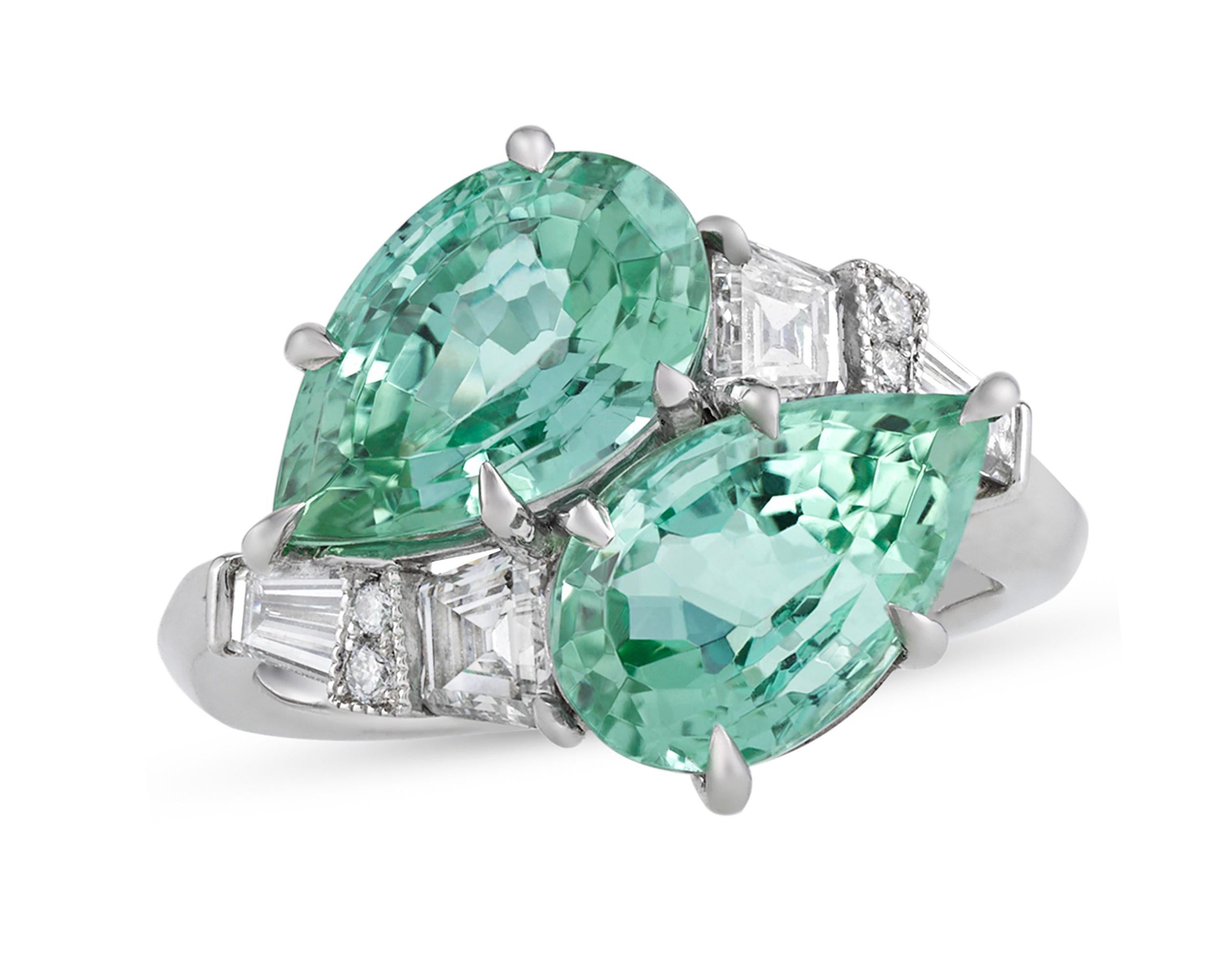 The refreshing and crisp green hue of the delectable mint tourmalines in this Raymond Yard bypass ring brings to mind the coming of spring. Weighing 5.96 combined carats, these pear-shaped gemstones reside in their platinum setting amongst baguette,