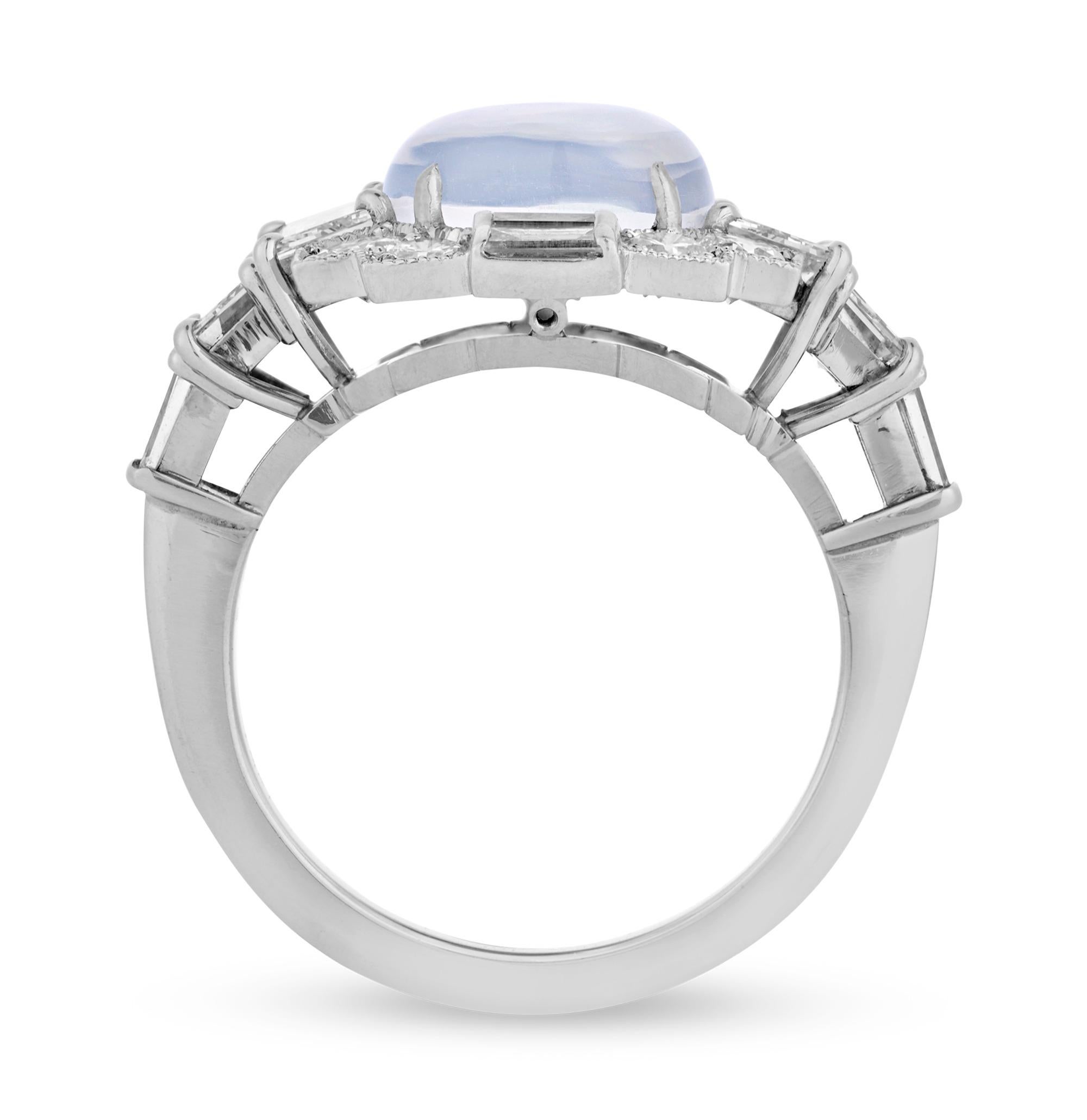 This enchanting ring by the prestigious American designer Raymond Yard showcases a luminous cushion shaped moonstone totaling 3.64 carats. The ethereal stone is accented by trapeze, tapered baguette, baguette and round cut white diamonds