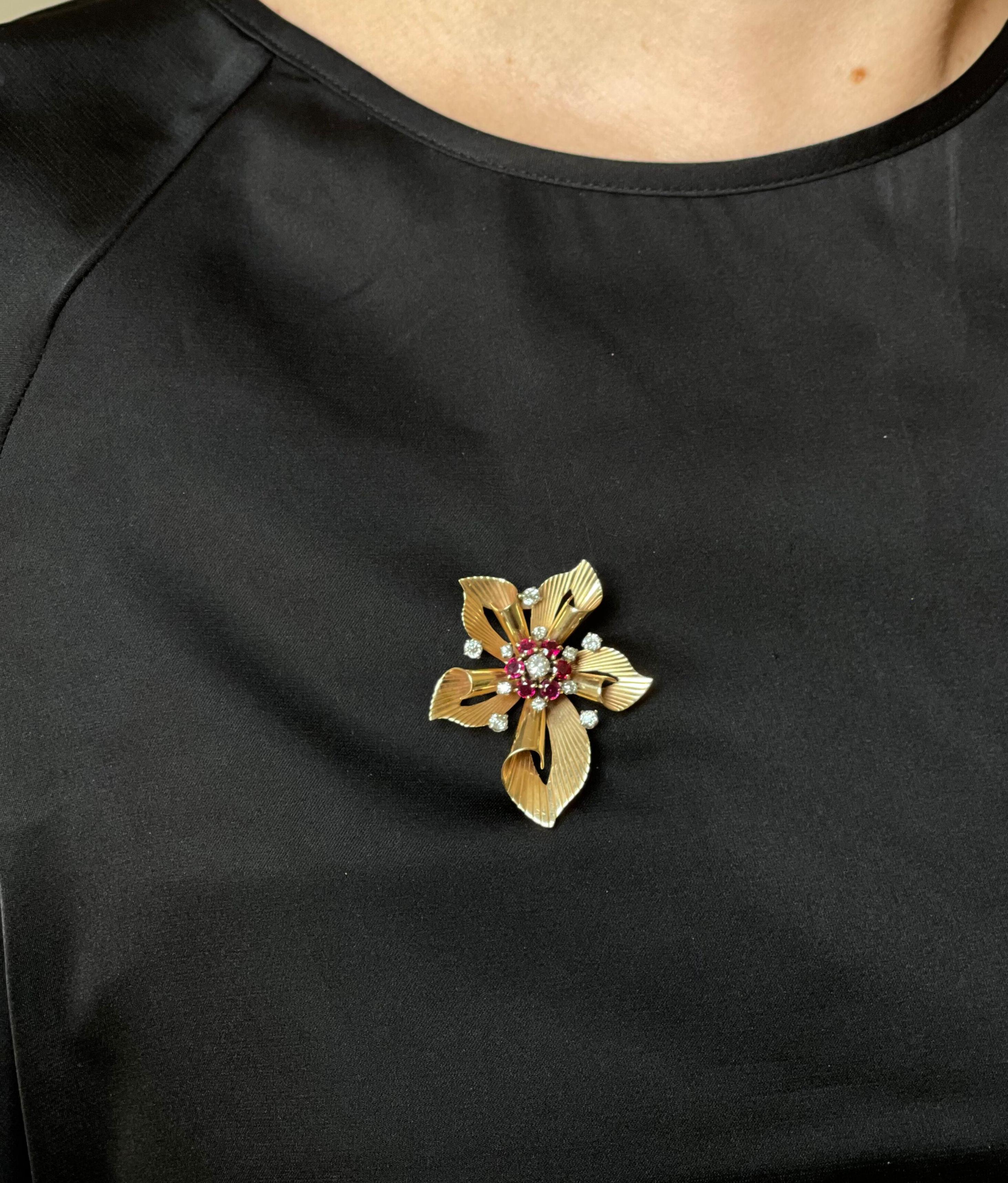 Retro classic 14k gold flower brooch by Raymond Yard, set with vibrant rubies and approx. 0.65ctw in diamonds. Brooch measures 1.75