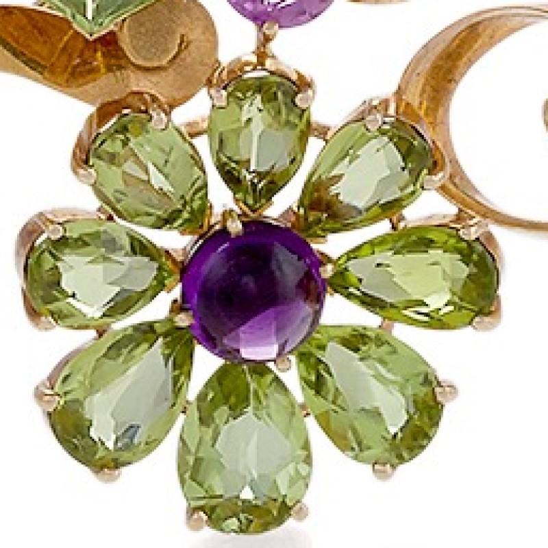 An American Retro 14 karat polished yellow gold brooch with peridots, pink sapphires and amethyst by Raymond Yard. The brooch has 20 mixed cut peridots with an approximate total weight of 8.00 carats, 6 mixed cut pink sapphires with an approximate