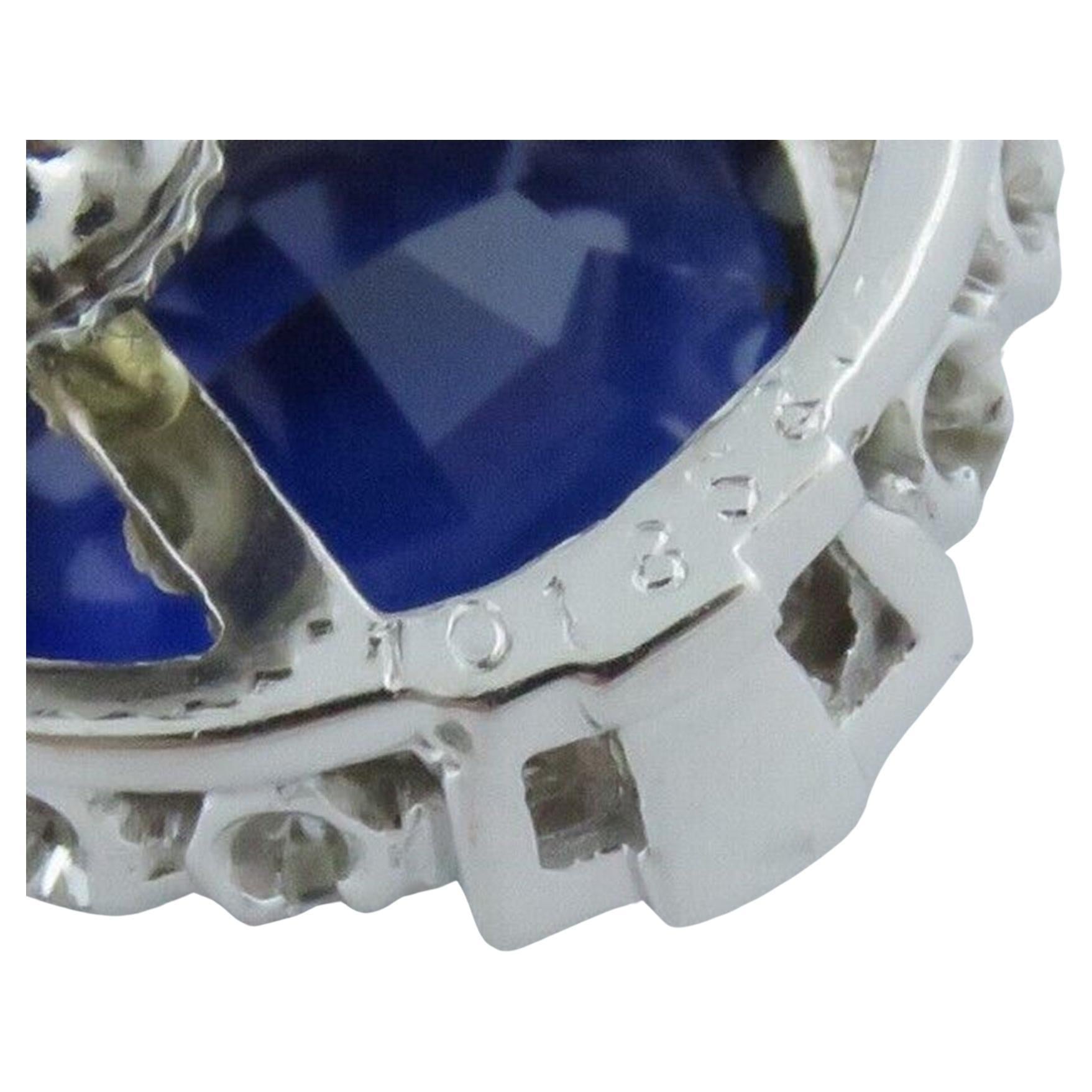 Indulge in the exquisite craftsmanship of these Raymond Yard earrings, featuring approximately 1.25 carats of natural diamonds, primarily in the F-G color and VS clarity range. Each earring is adorned with a genuine sapphire, measuring around