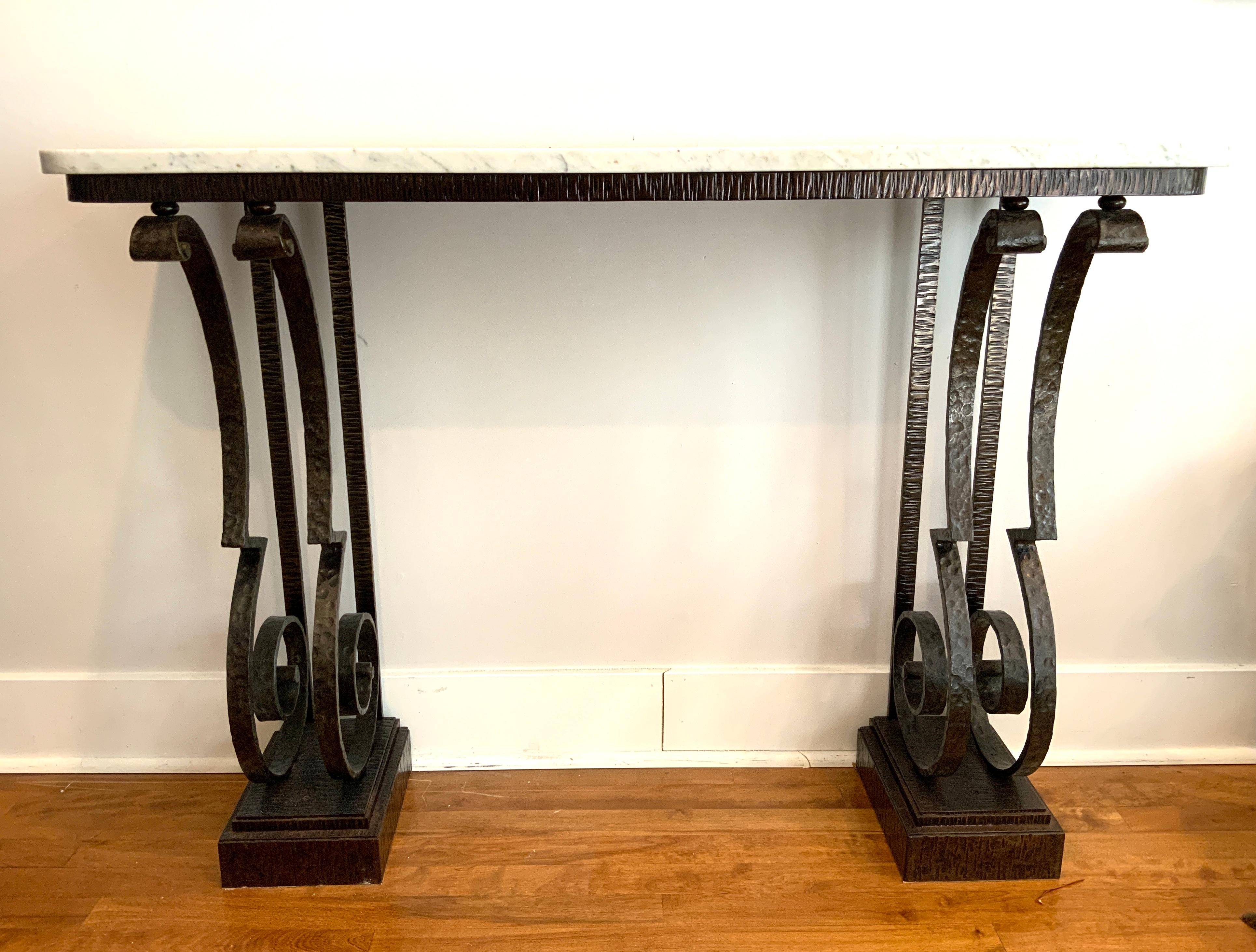 An exceptional Art Deco console table made from hand-hammered wrought iron (“fer forgé martelé” in French) with a white-veined marble top, ca. 1930’s, attributed to, we believe, Raymond Subes (1891-1970), the French Art Deco master metalworker and a