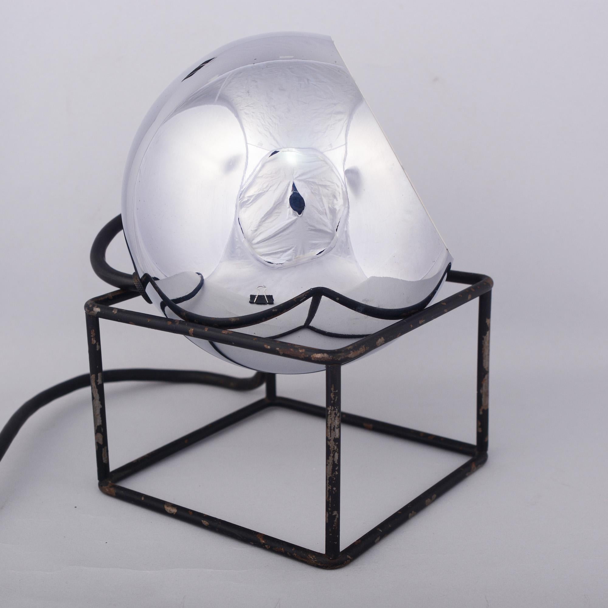 Midcentury chrome ball spot light distributed by Raymor. The chrome ball rests on an architectural iron cage base. This is the shortest version of this lamp. The lamp is all original. There is paint loss on the base and some discoloration of the