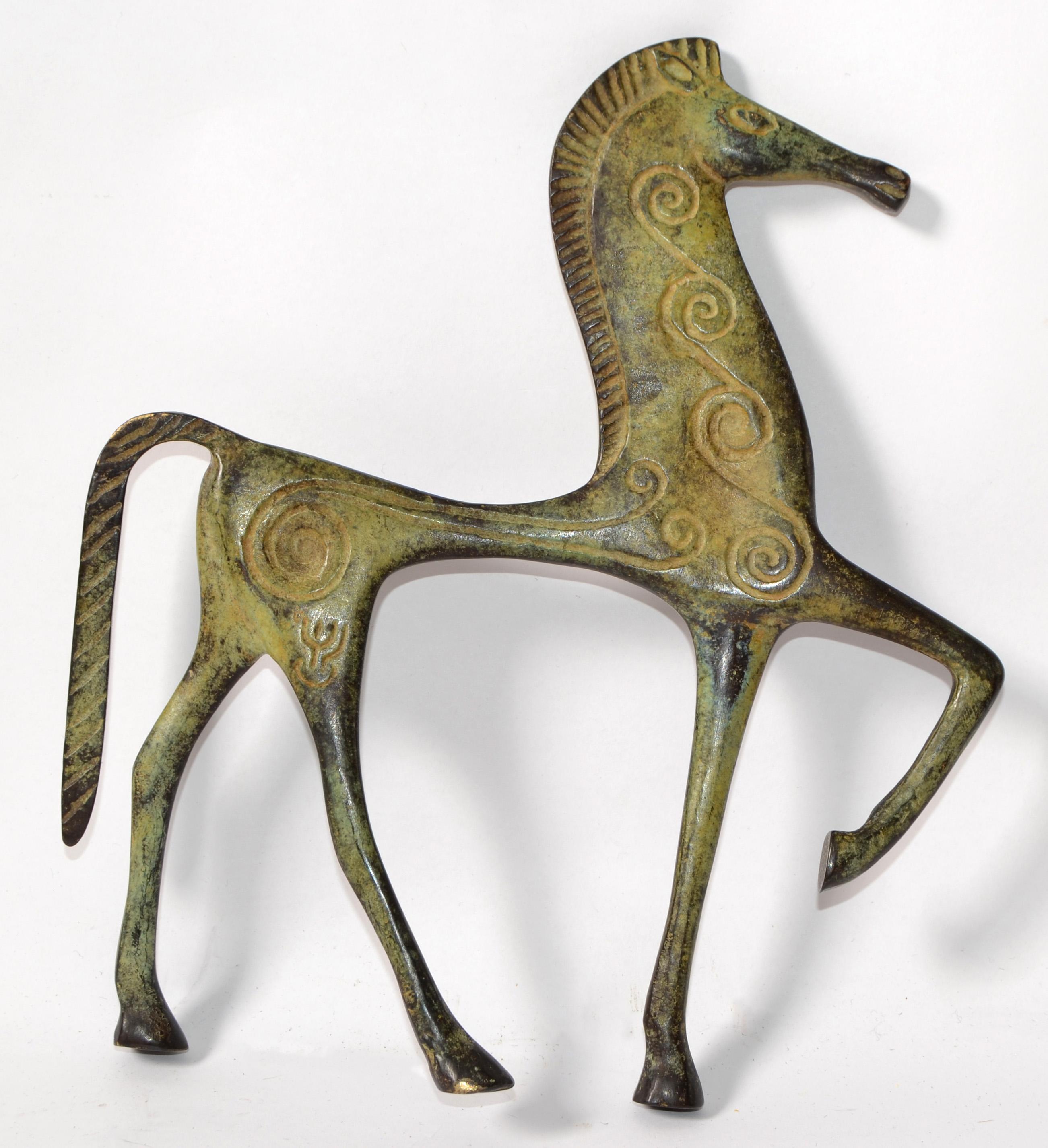 This is a bronze sculpture, which may have been done by Frederic Weinberg for Raymor.
It is an incredibly stylized Roman decorated horse Figurine and has a patina finish. Italian-made and great for any Mid-Century Modern interior.
It looks like the
