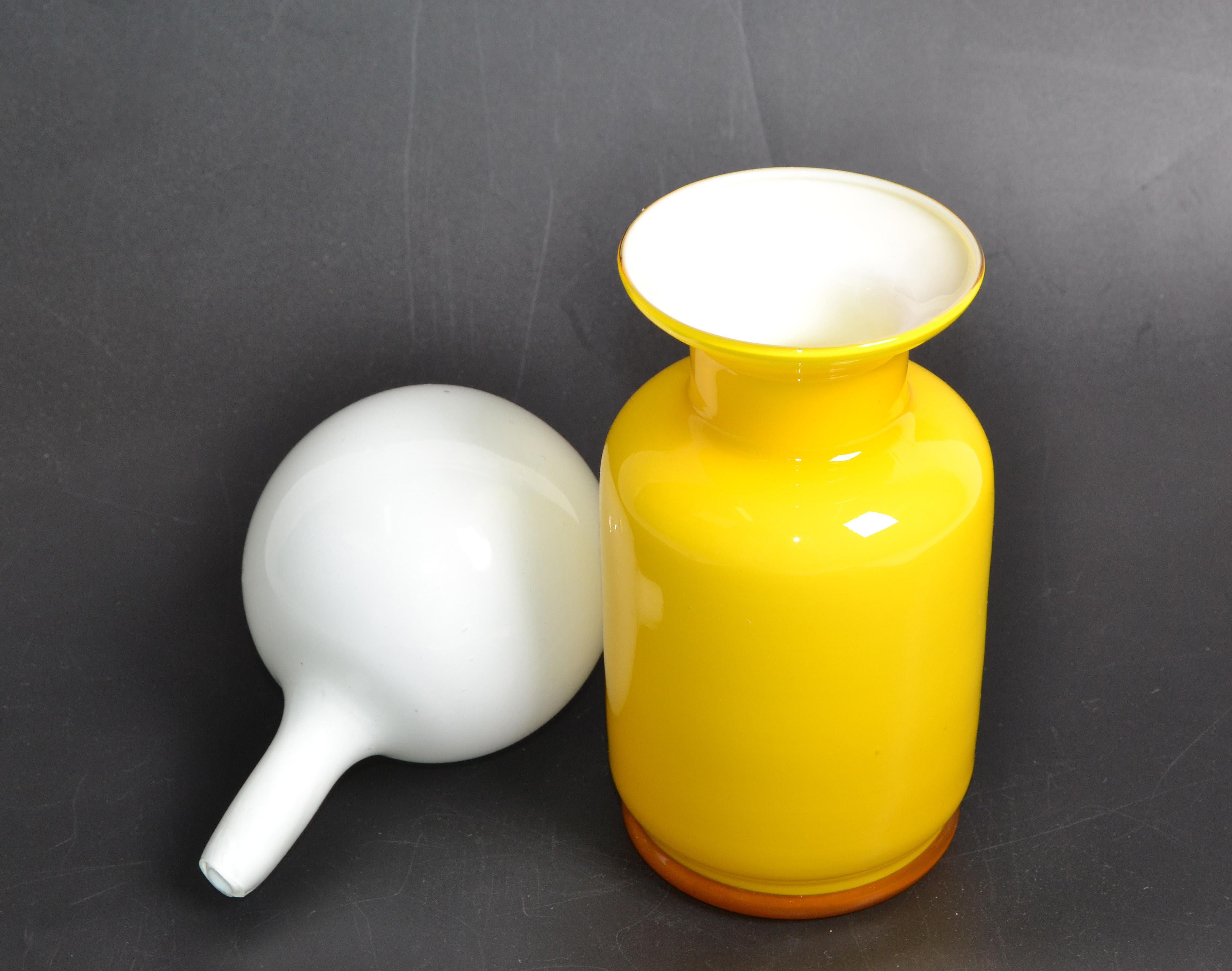 Mid-Century Modern Decanter or Vessel made out of blown glass in bright yellow and white stopper by Raymor, Italy.
Marked and dated underneath.
A gorgeous vessel for your holiday table.
 