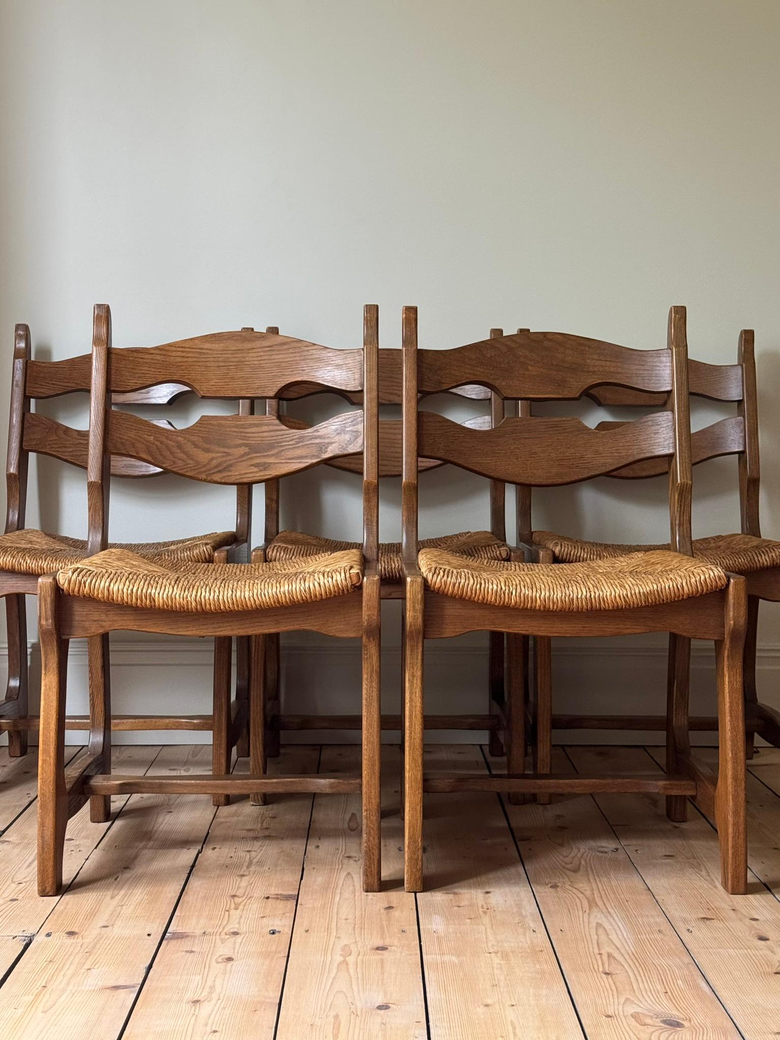 A set of five razor back dining chairs designed by Robert Guillerme and Jacques Chambron. Solid oak frames and original rush seats. Good vintage condition and sturdy with some age-related signs of wear.

H89 x W50 x D44cm