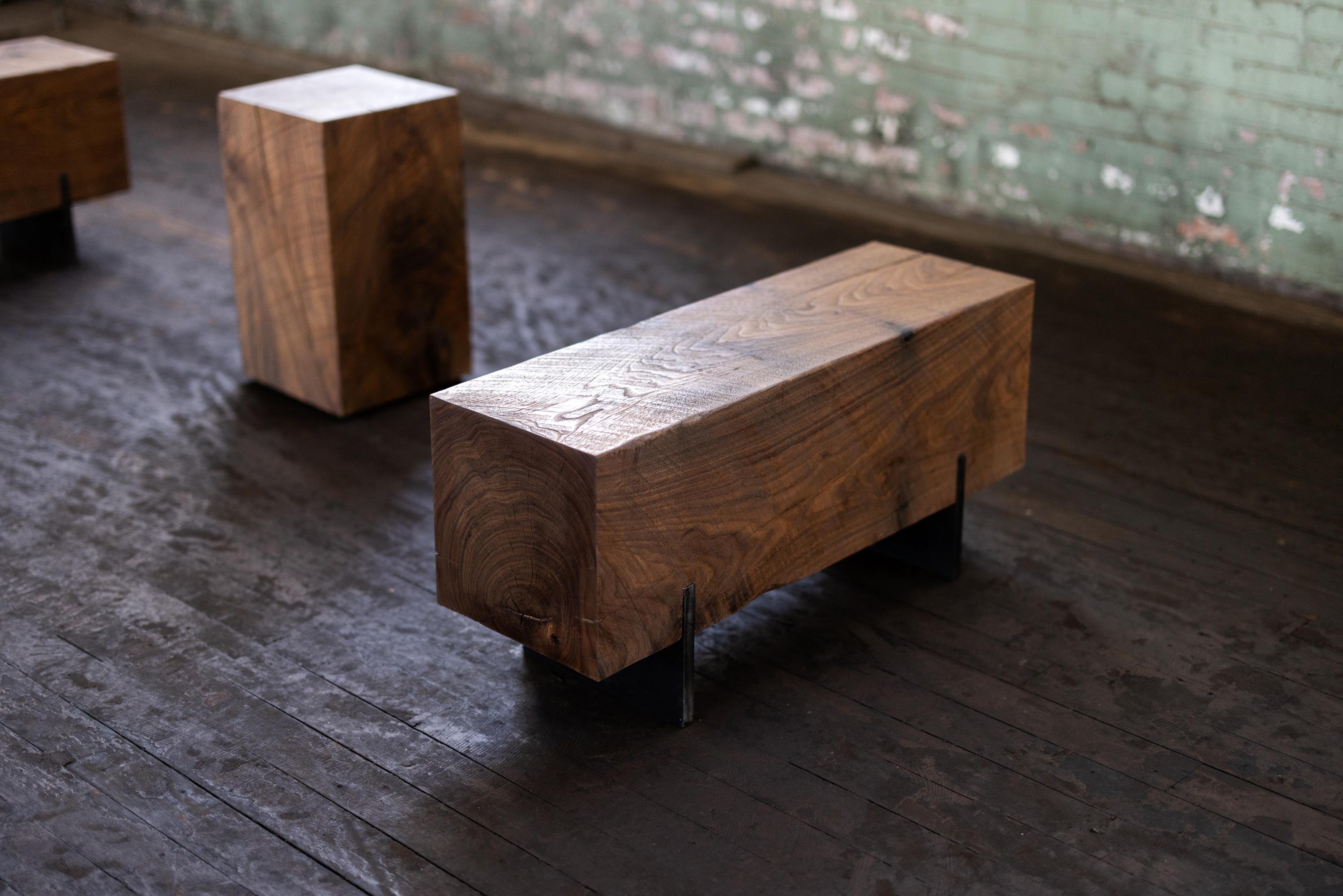 Our knife beam bench in walnut utilizes salvaged walnut wood logs for a rustic bench. Narrow and backless, the simple lines express the natural texture of the end grain of each species. The 12