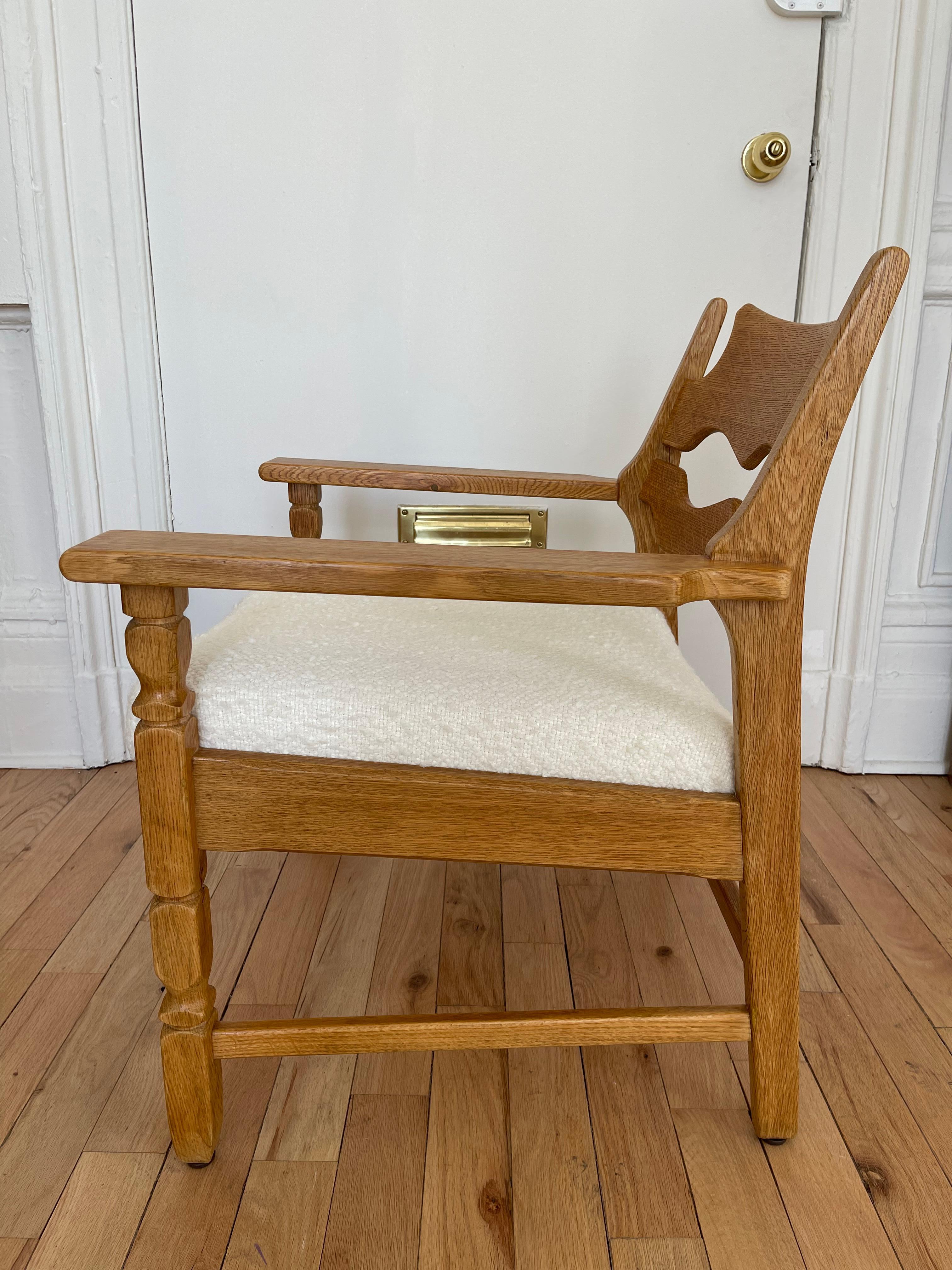 A pair of solid oak easy chairs with 