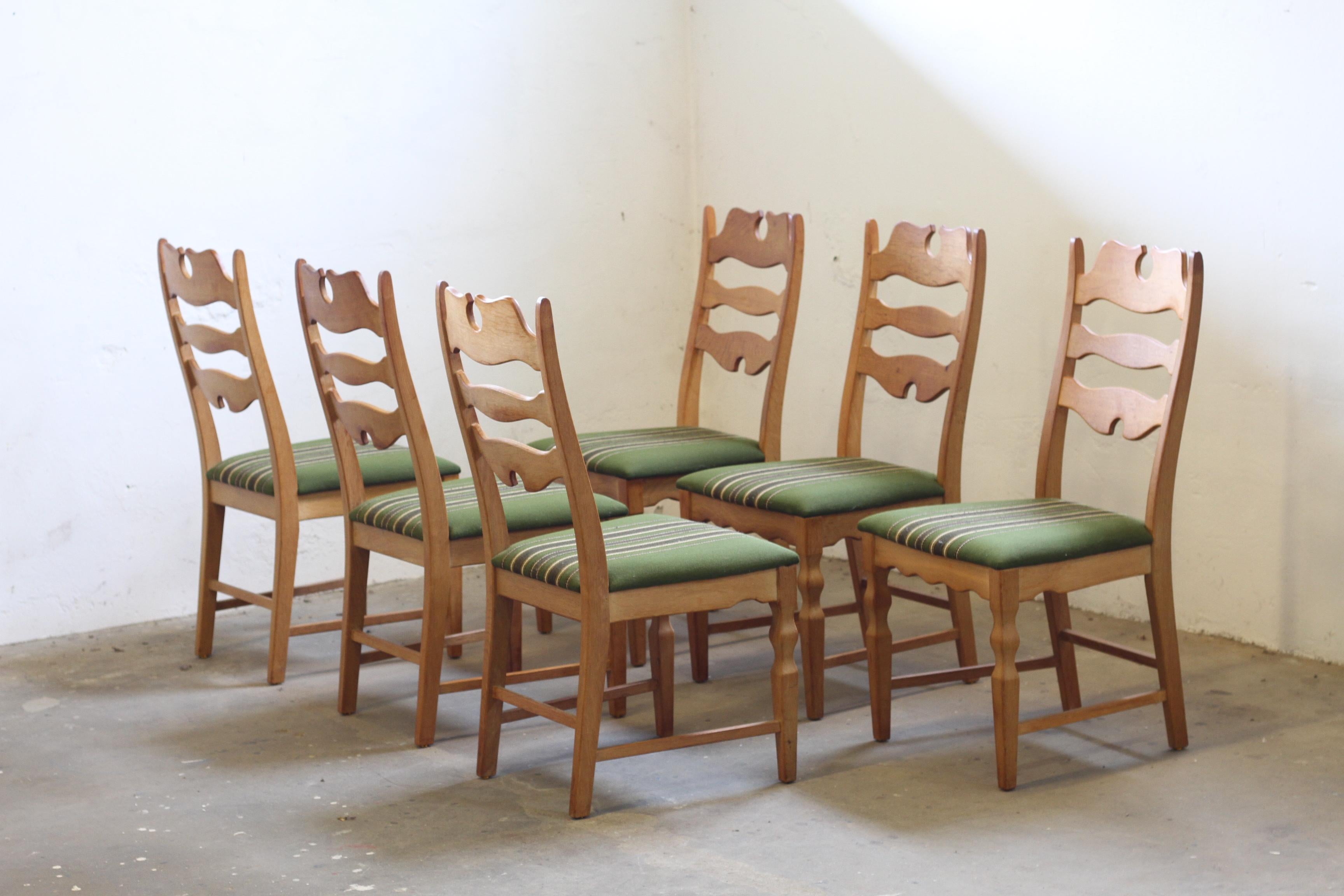 This set of six carved light oak ladder-back chairs, known as the 
