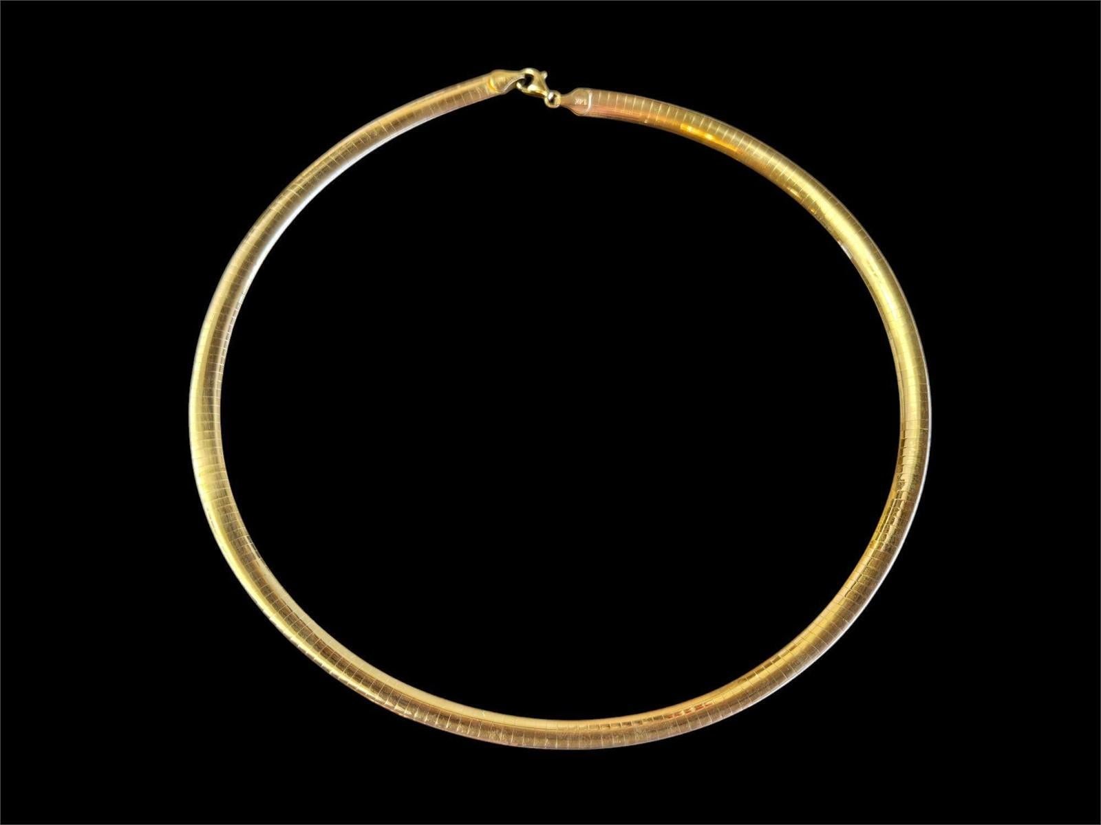This necklace is just beautiful.  It is pre-owned but just like new.  It's been very well-cared for.  You can reverse it from 18k Yellow Gold to 18k White Gold  It lays on the neck equally as good on either side.  It just hugs your neck.  It is just