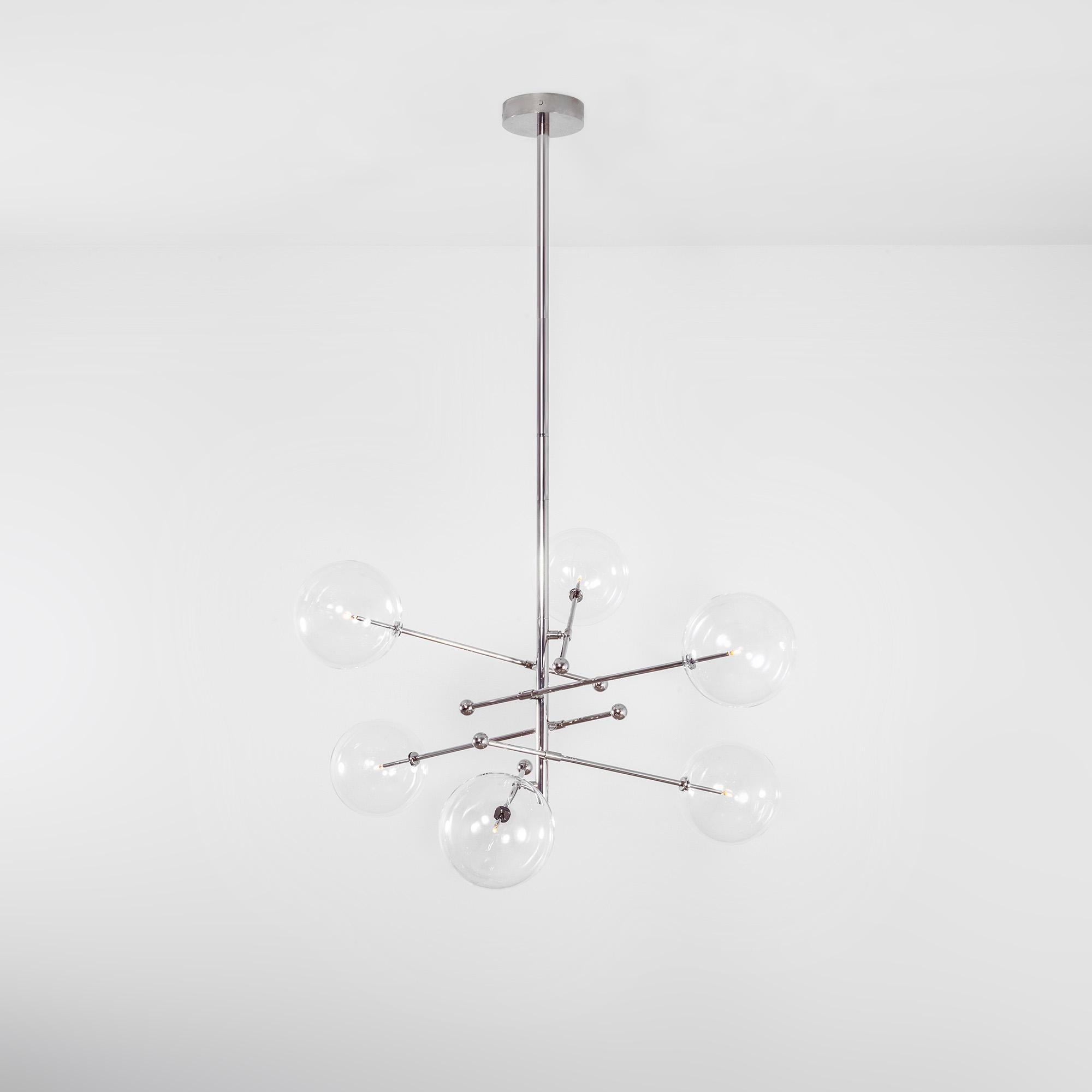 Polished Nickel 6 arm chandelier by Schwung
Dimensions: Diameter 139 x Height 165.1 cm
Materials: Solid brass, hand-blown glass globes
Finish: Polished Nickel.
Also available in finishes: Natural Brass or Black Gunmetal.
All our lamps can be