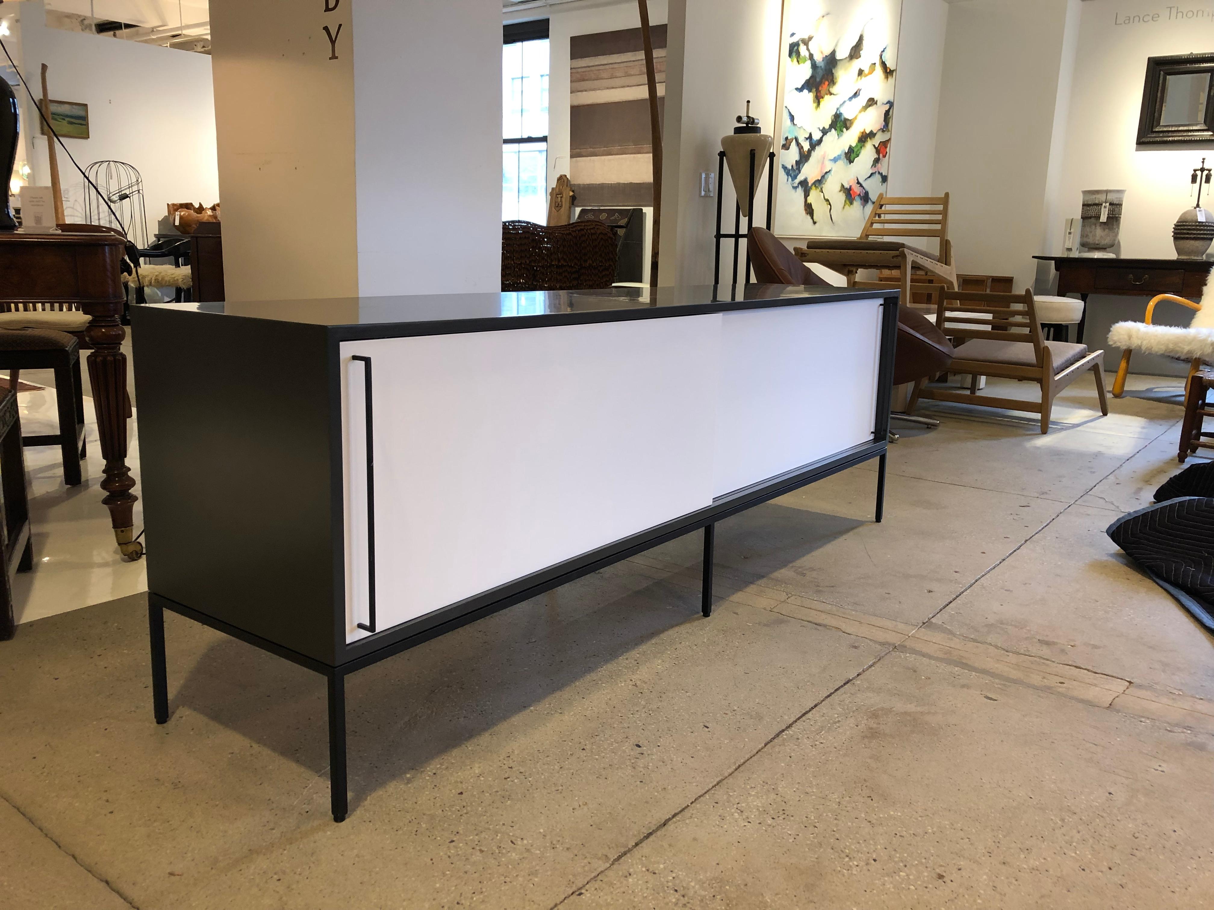 This sleek lined credenza with metal accents is extremely versatile and can be ordered in many ways.  We currently have it in stock in several different finishes.  Email for current availability.