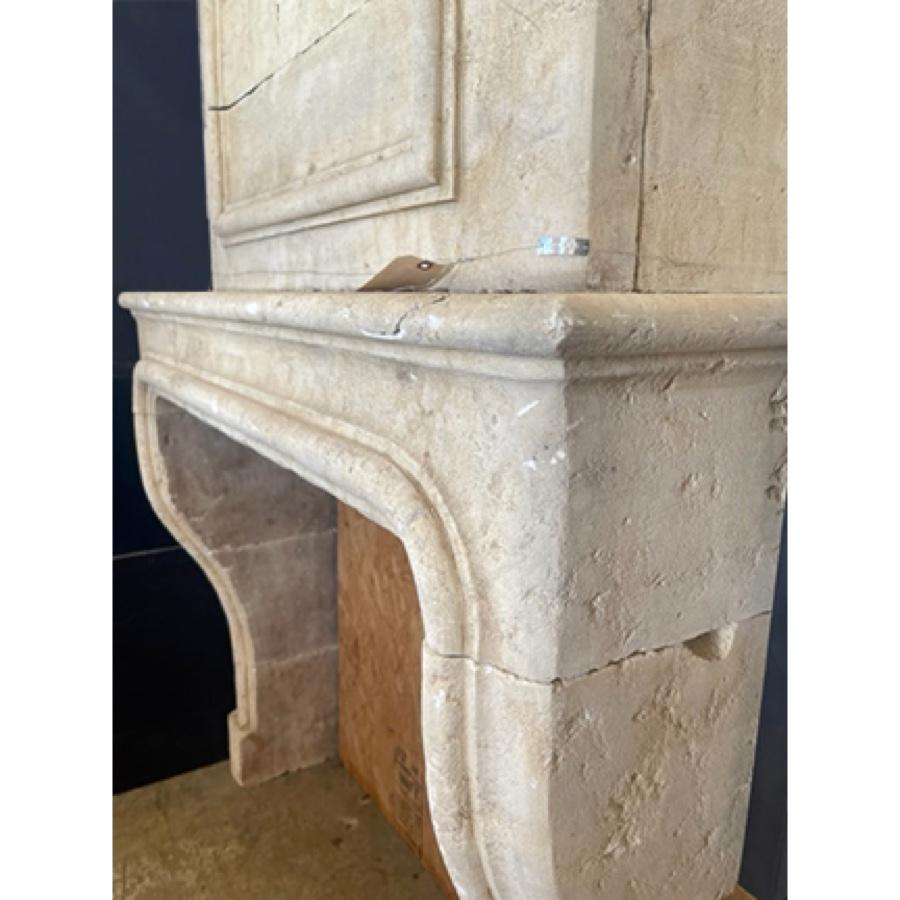 Re-Edition French Limestone Fireplace with Trumeau In Fair Condition For Sale In Scottsdale, AZ