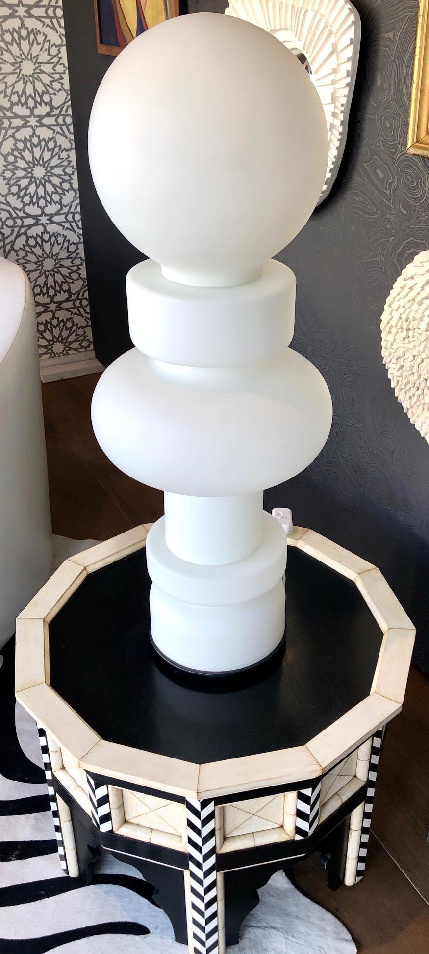 Impressive scaled mid-height floor or table lamp comprised of three pieces o milky-white glass. Designed by artist and theorist Bobo Piccoli. 
