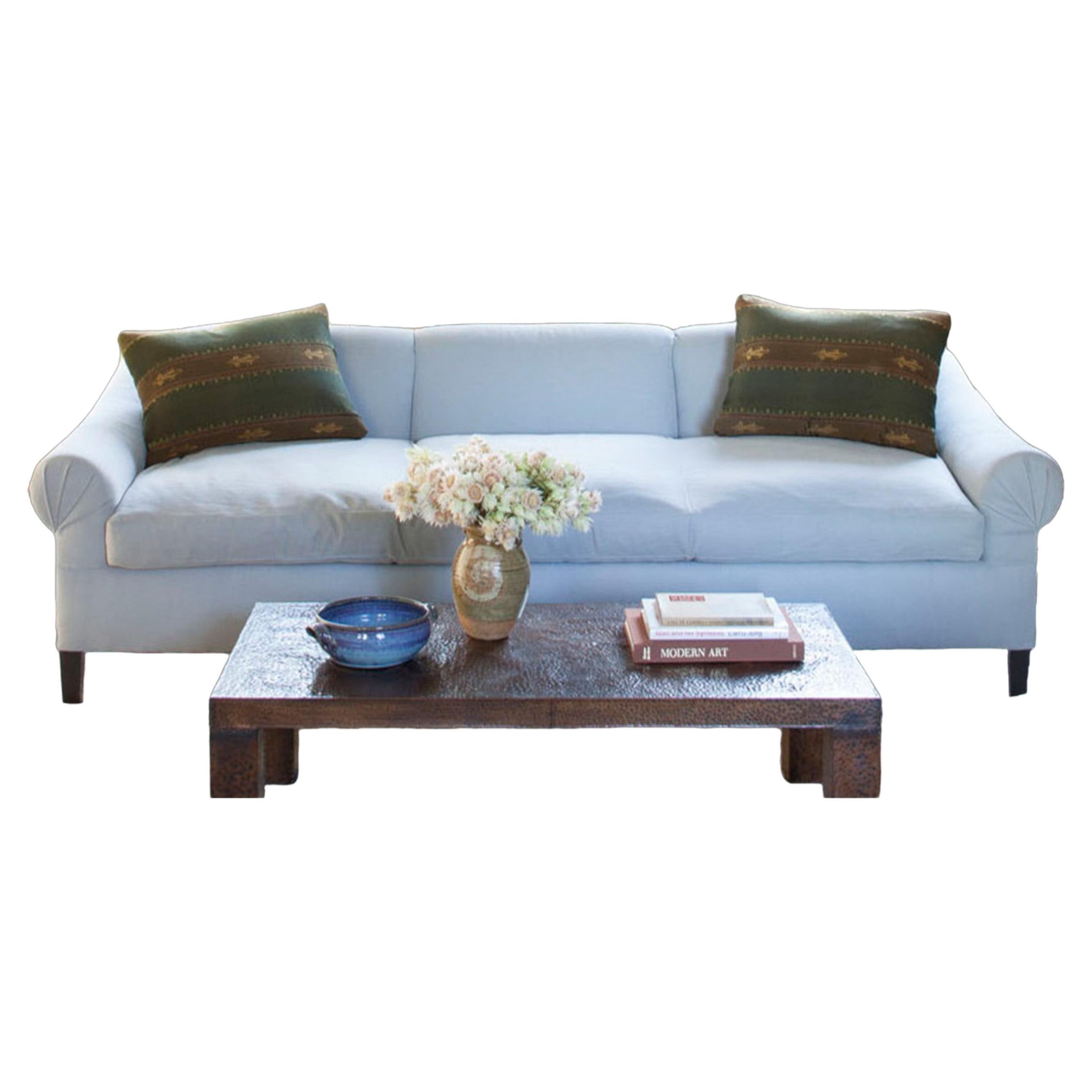 Scroll arm sofa featuring bench seat cushion and classic, American detailing. The Reade sofa frame is constructed using solid maple wood with 50 / 50 down feather filled cushions. Four finishes available for sofa legs. Available in four cotton