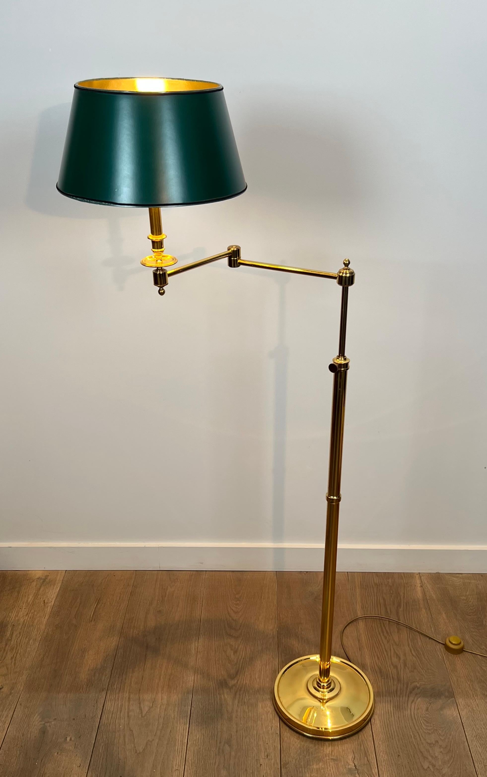 This very nice reading lamp is made of a removable brass arm and a synthetic green shade in painted sheet metal style. French work in the style of Maison Jansen. Circa 1970