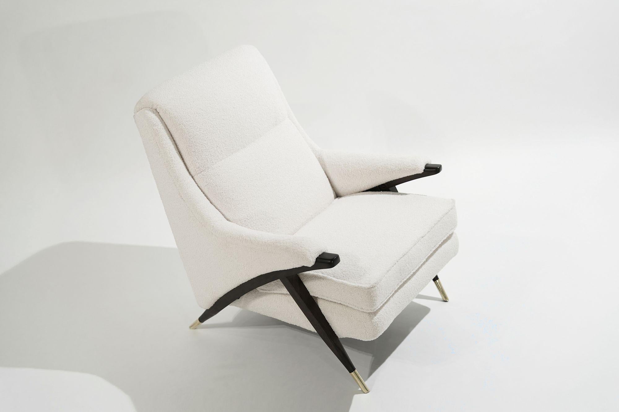 A very comfortable lounge chair by The Karpen Company of California, circa 1950-1959. Completely restored down to its frame, fitted with all new springs, foam, straps, and dacron. Reupholstered in off-white Italian bouclé. Walnut arms and legs were