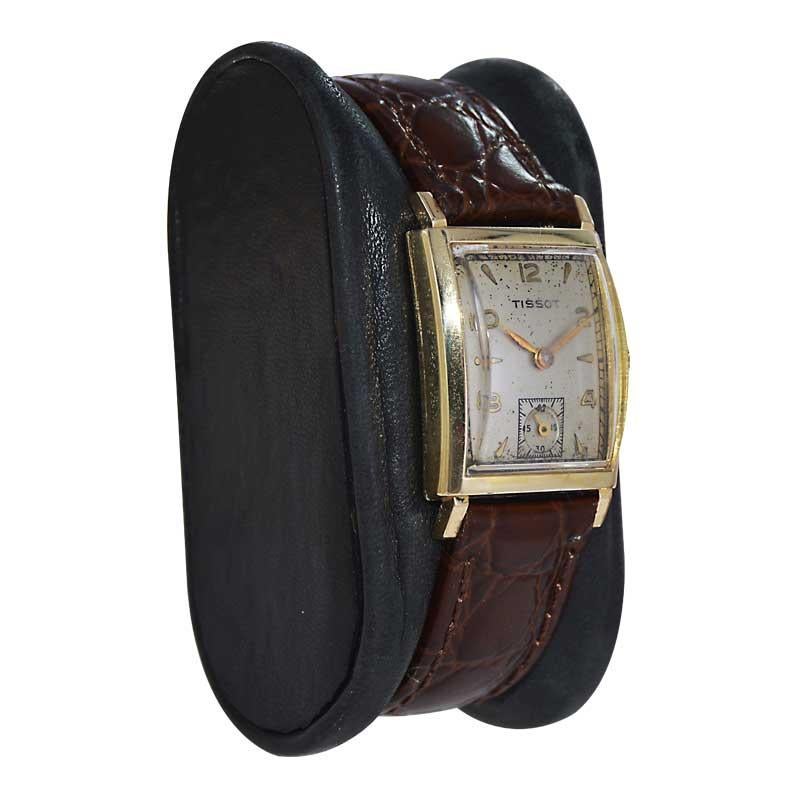 FACTORY / HOUSE: Tissot Watch Company
STYLE / REFERENCE: Art Deco / Tank Style
METAL / MATERIAL: Yellow Gold Filled 
CIRCA / YEAR: 1940's
DIMENSIONS / SIZE: Length 32mm X Width 21mm
MOVEMENT / CALIBER: Manual Winding / 17 Jewels 
DIAL / HANDS: