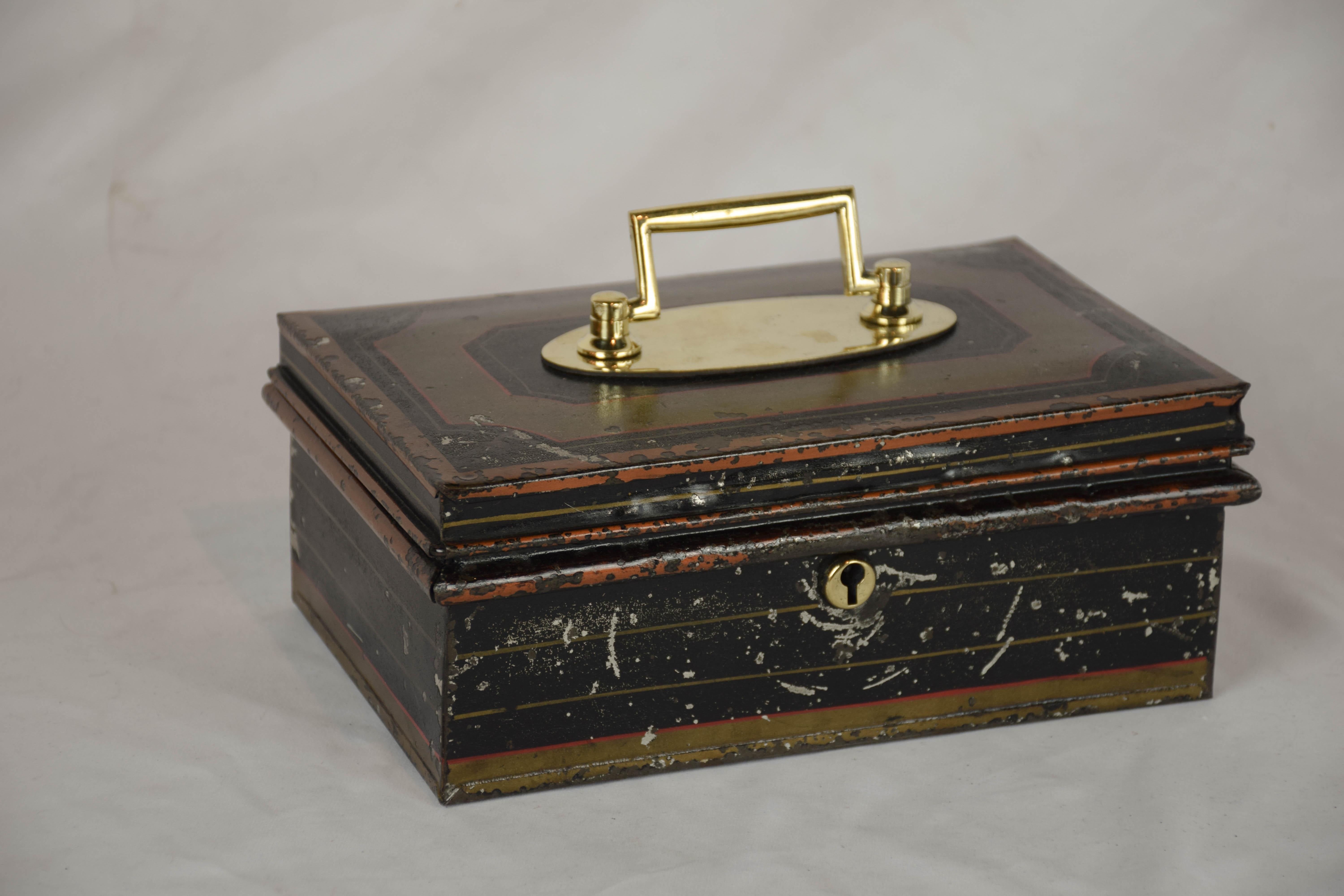 This 19th century English cash box is all original. The box when open has an insert with 2 compartments with hinged lids and a handle. The box has its original black and gold paint.
  
