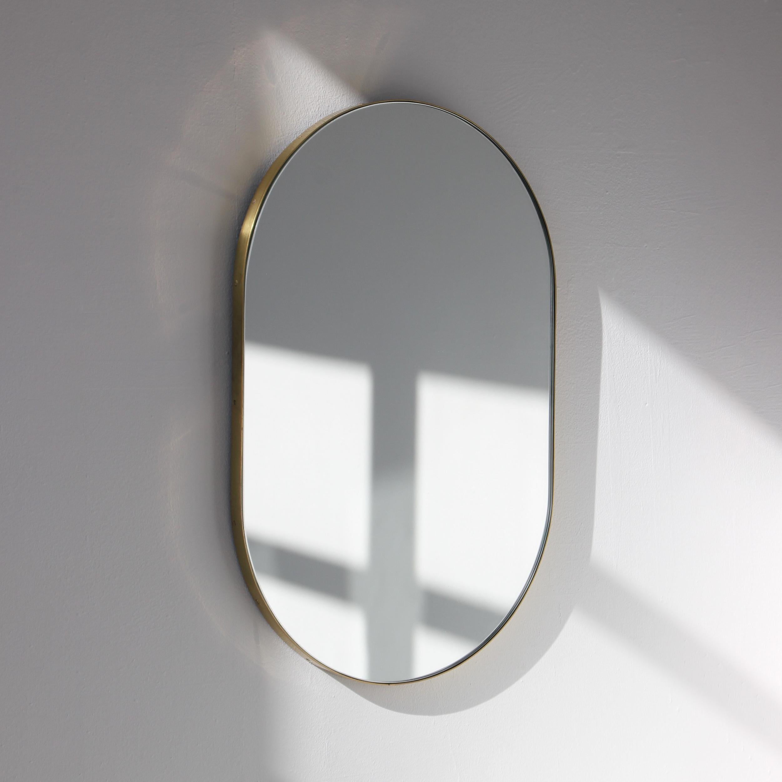 Delightful handcrafted capsule shaped mirror with a solid brushed brass frame and a demister pad. Designed and handcrafted in London, UK.

Fitted with a brass hook or an aluminium z-bar depending on the size of the mirror. Also available on demand