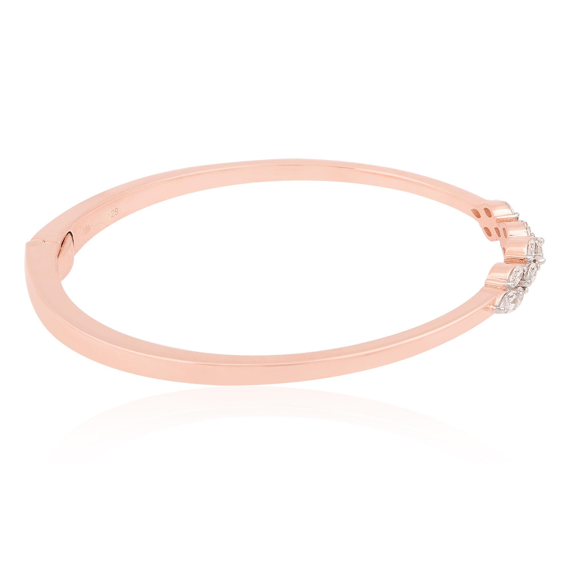 The graceful curvature of the marquise diamond is perfectly complemented by the sleek, sculptural design of the cuff bangle bracelet, expertly crafted in lustrous 18 Karat Rose Gold. The warm, rosy hue of the gold enhances the beauty of the diamond,