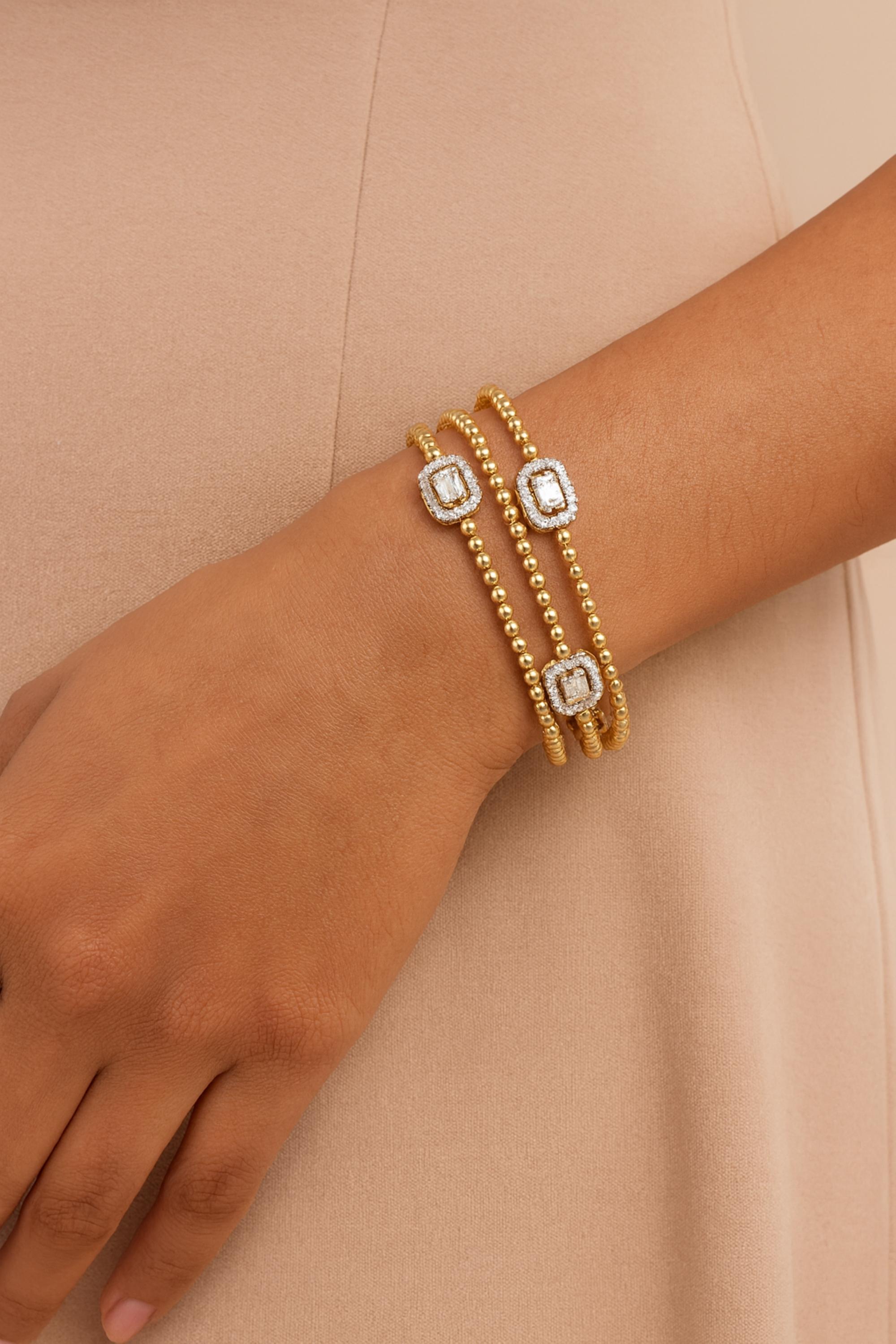 Real 0.85 Carat SI/H Baguette Diamond 18k Yellow Gold Beaded Wide Cuff Bracelet 
It is an open-cuff bracelet or bangle, meaning it has a gap on one side allowing it to be slipped onto the wrist. The bracelet is composed of three parallel bands or