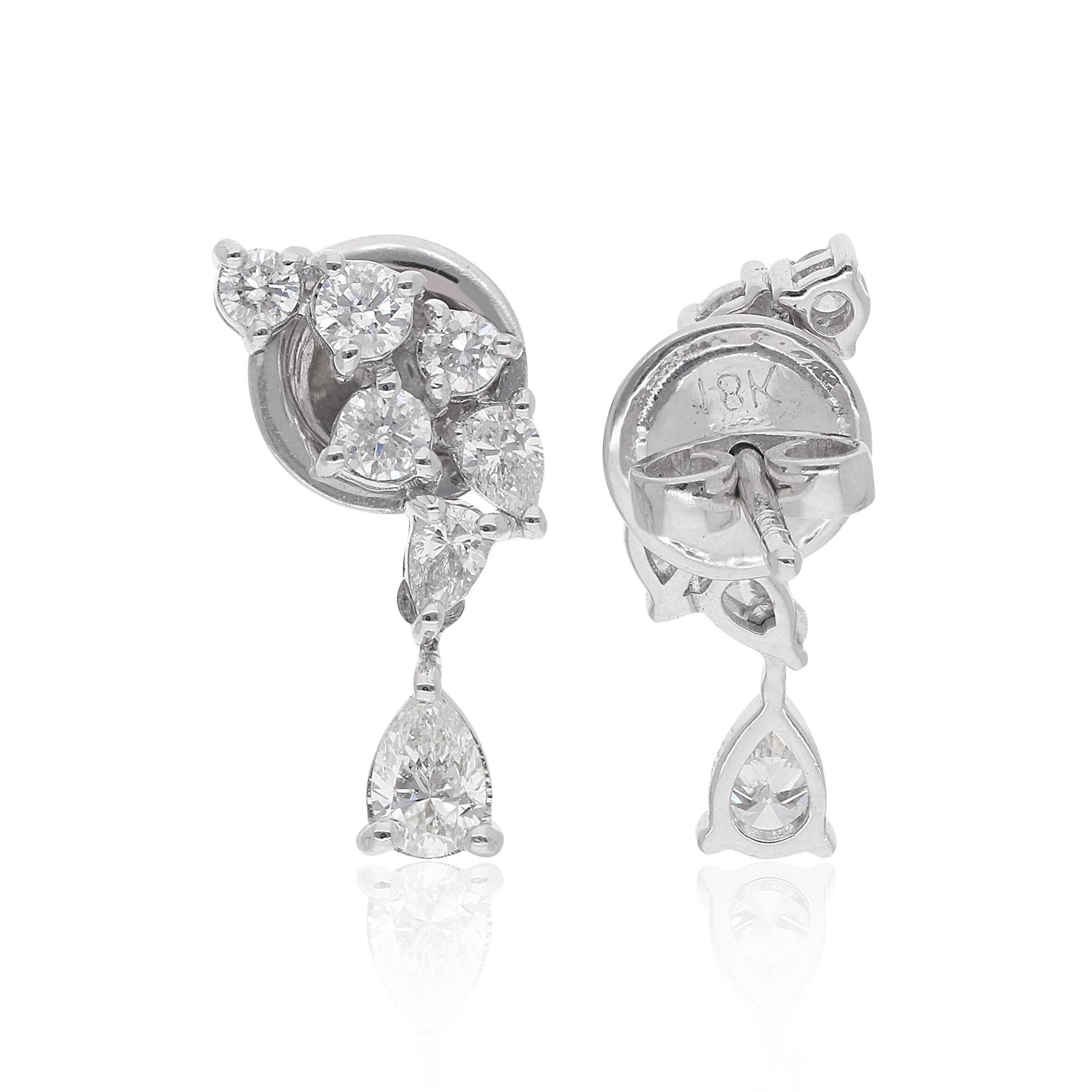 Step into the realm of sophistication with these stunning pear and round diamond dangle earrings, meticulously crafted in 18 karat white gold. Each earring showcases a captivating combination of pear-shaped and round diamonds totaling 0.86 carats,