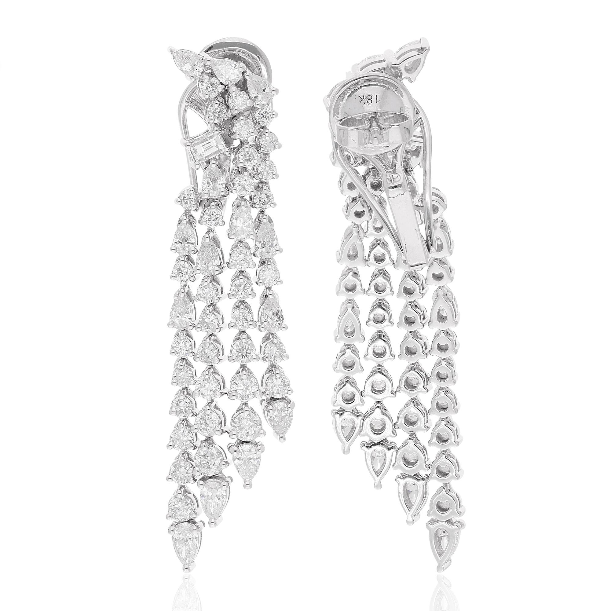 The dangle design of these earrings creates a sense of fluidity and grace, allowing the diamonds to catch the light from every angle. Crafted with meticulous attention to detail, these earrings are designed to make a statement while remaining