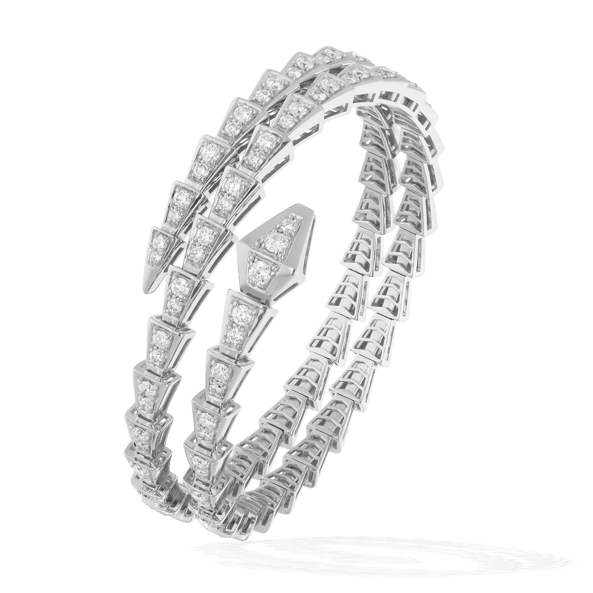 At its heart lies a magnificent 4.82 carat diamond, boasting SI clarity and HI color, radiating brilliance and fire with every movement. Set in a striking snake design, the diamonds coil around the wrist in a captivating embrace, exuding a sense of