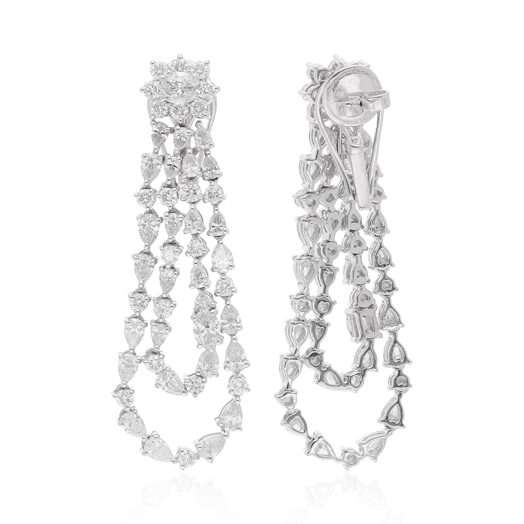 Set in luxurious 18 karat white gold, the diamonds radiate with unparalleled brilliance, enhanced by the purity and luminosity of the precious metal. The sophisticated dangle design adds movement and allure to the earrings, ensuring they catch the