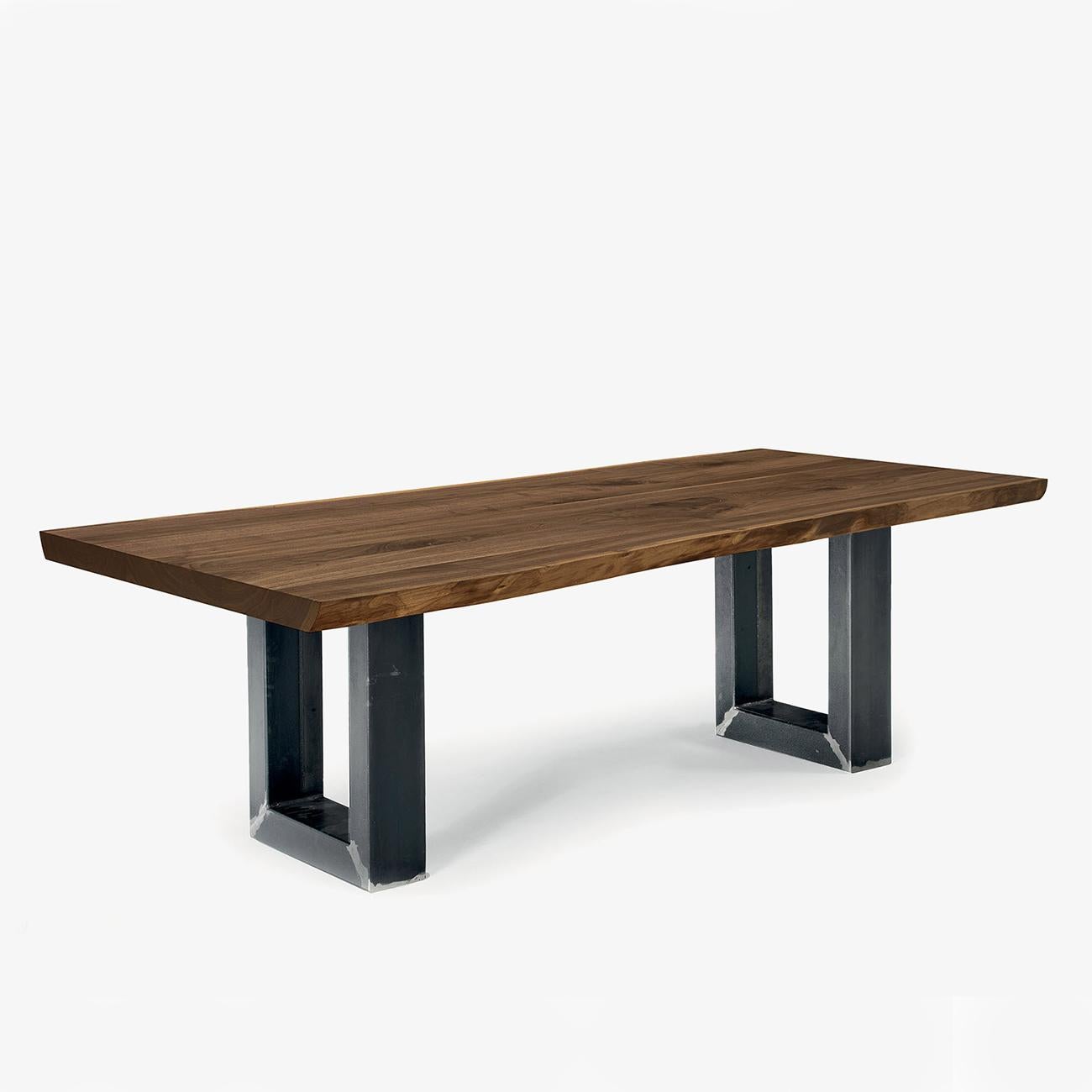 Dining table real edges walnut with solid walnut top,
6.5 mm thickness and with real wood slats edges. With
2 iron U-shape base, with visible weld joints, iron in oiled
finish. Available in:
L 200 x D 100 x H 75cm, price: 9900,00€.
L 220 x D100 x H