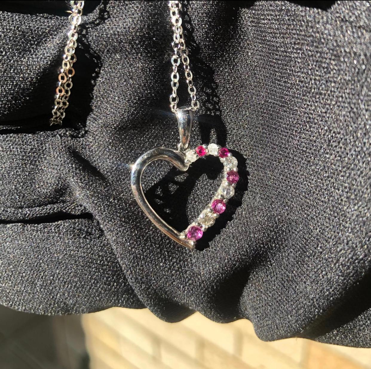 Cute diamond heart pendent. 

Approx. 3/4 carat total weight of natural genuine earth mined diamonds and rubies. The gemstones sparkle beautifully in the light. 

Pendent is stamped 10k white gold and has all the visible markings. Comes with a
