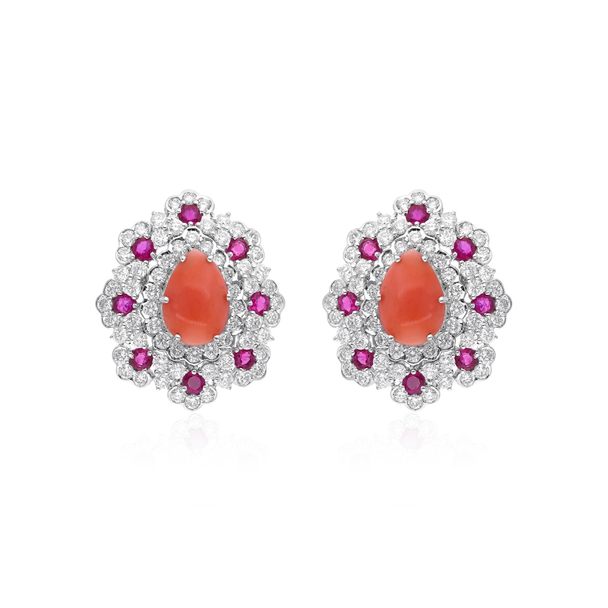 Engarzados en el mejor oro blanco de 14 quilates, estos pendientes son un testimonio de artesanía de lujo. El brillo de las gemas de coral se ve acentuado por el conjunto de deslumbrantes rubíes y diamantes que las rodea. Cada piedra preciosa se