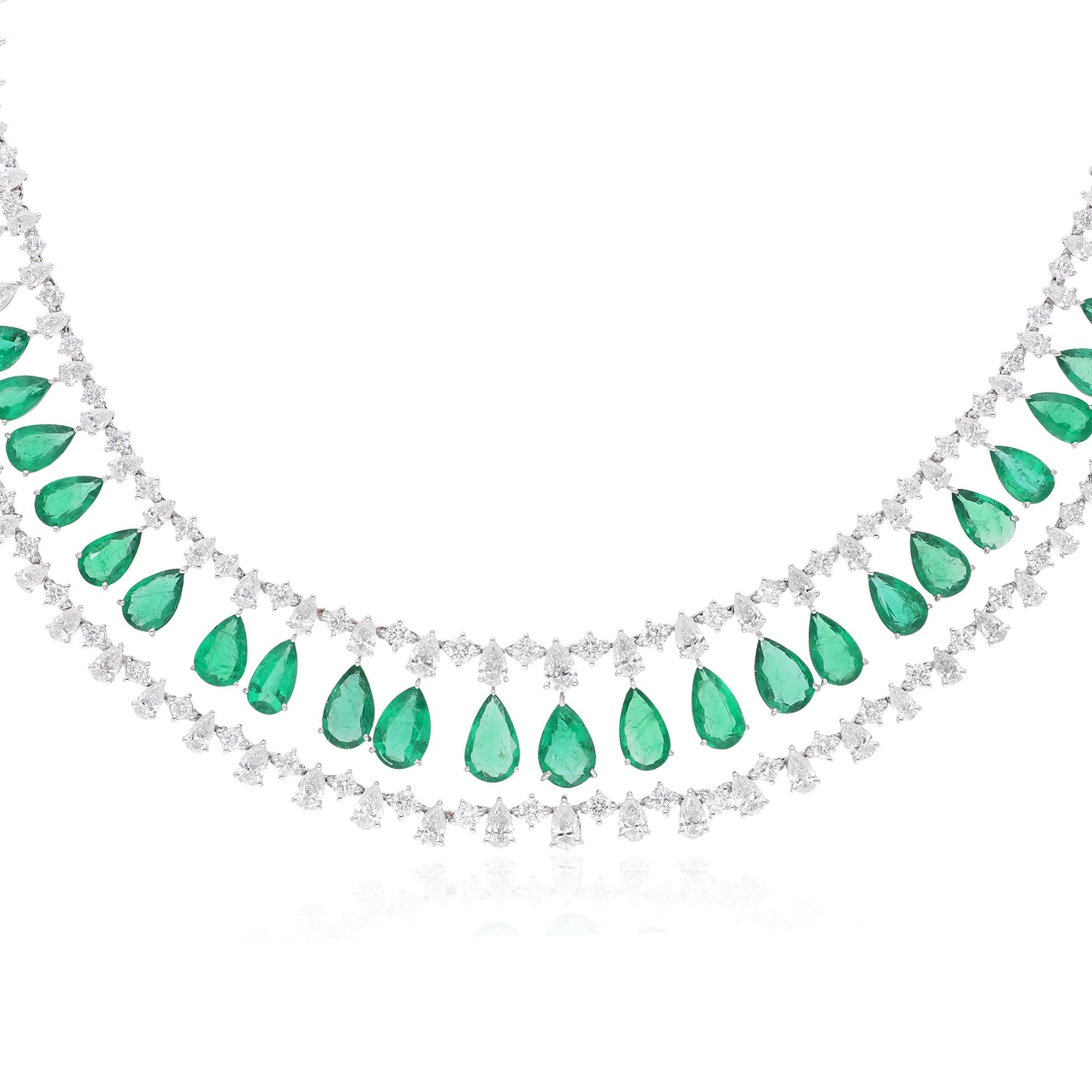 Surrounding the emerald are brilliant diamonds, meticulously set in 18 karat white gold to enhance their radiance and brilliance. These diamonds dance and shimmer with every movement, casting a spellbinding glow that complements the vibrant beauty