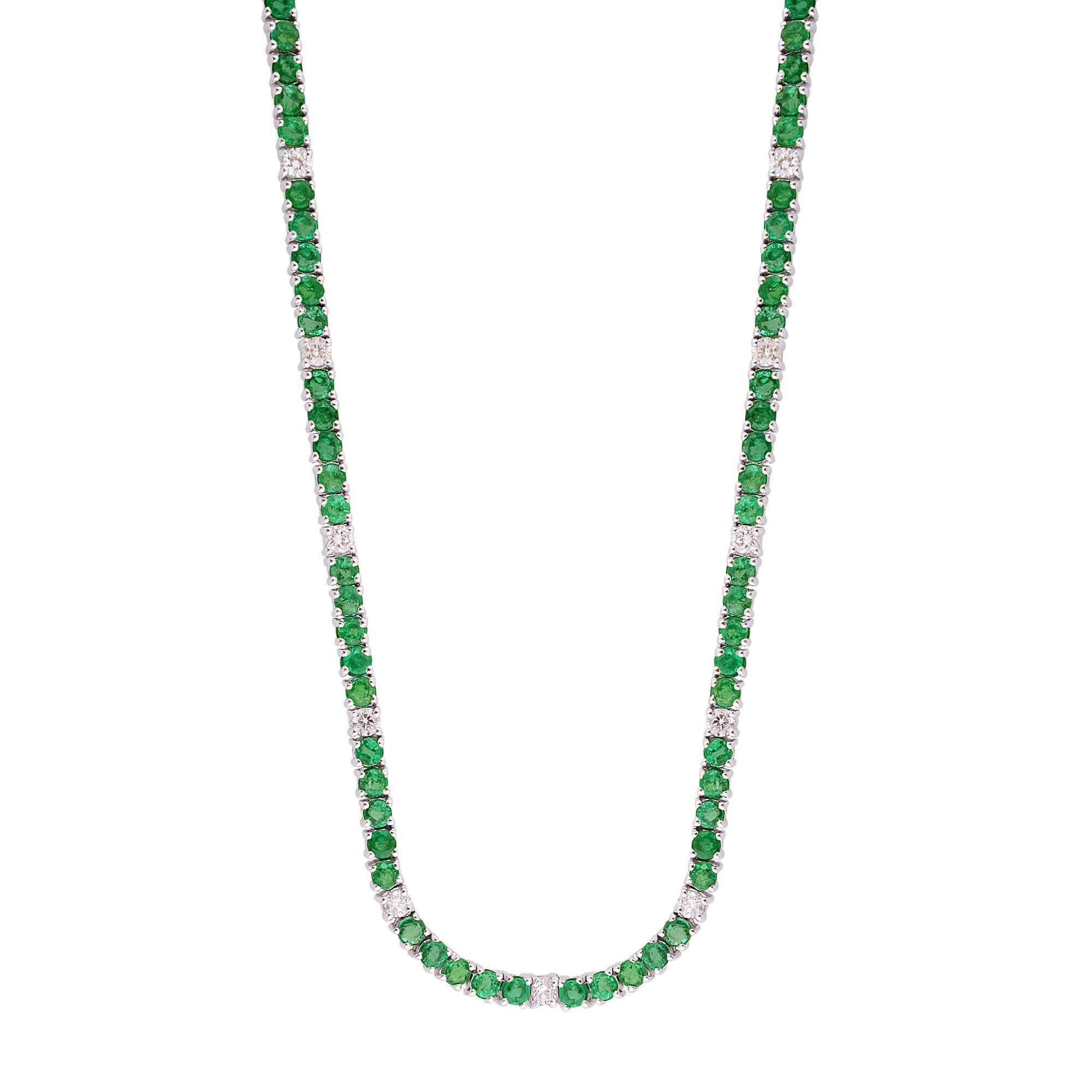 Surrounding the emerald are sparkling round-cut diamonds, meticulously set within the gleaming 10 Karat White Gold setting. These diamonds add a touch of glamour and sophistication to the necklace, enhancing the natural beauty of the emerald and
