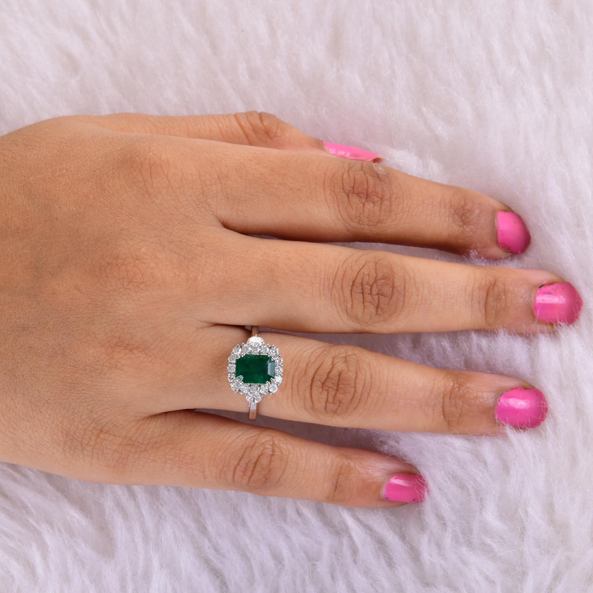 Surrounding the emerald are brilliant diamonds, meticulously set to enhance its beauty and create a dazzling display of light. The diamonds add a touch of glamour and sparkle to the design, accentuating the rich color and clarity of the emerald. Set