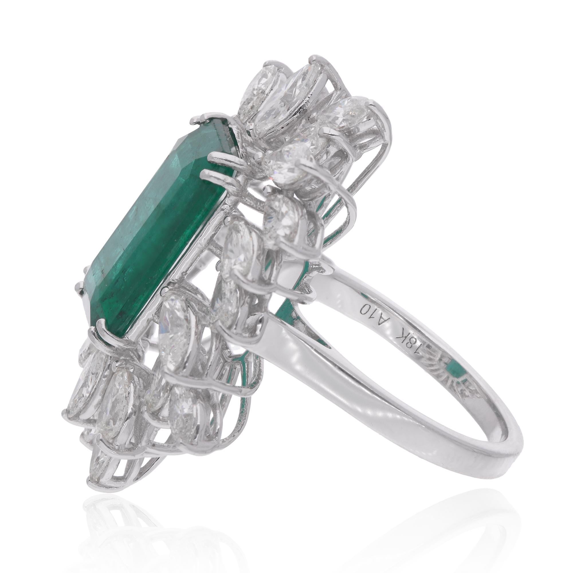 Surrounding the emerald centerpiece are shimmering Marquise Diamonds, meticulously set in a halo design. These Diamonds, selected for their exceptional sparkle and fire, add a touch of luxury and sophistication to the ring, enhancing the beauty of