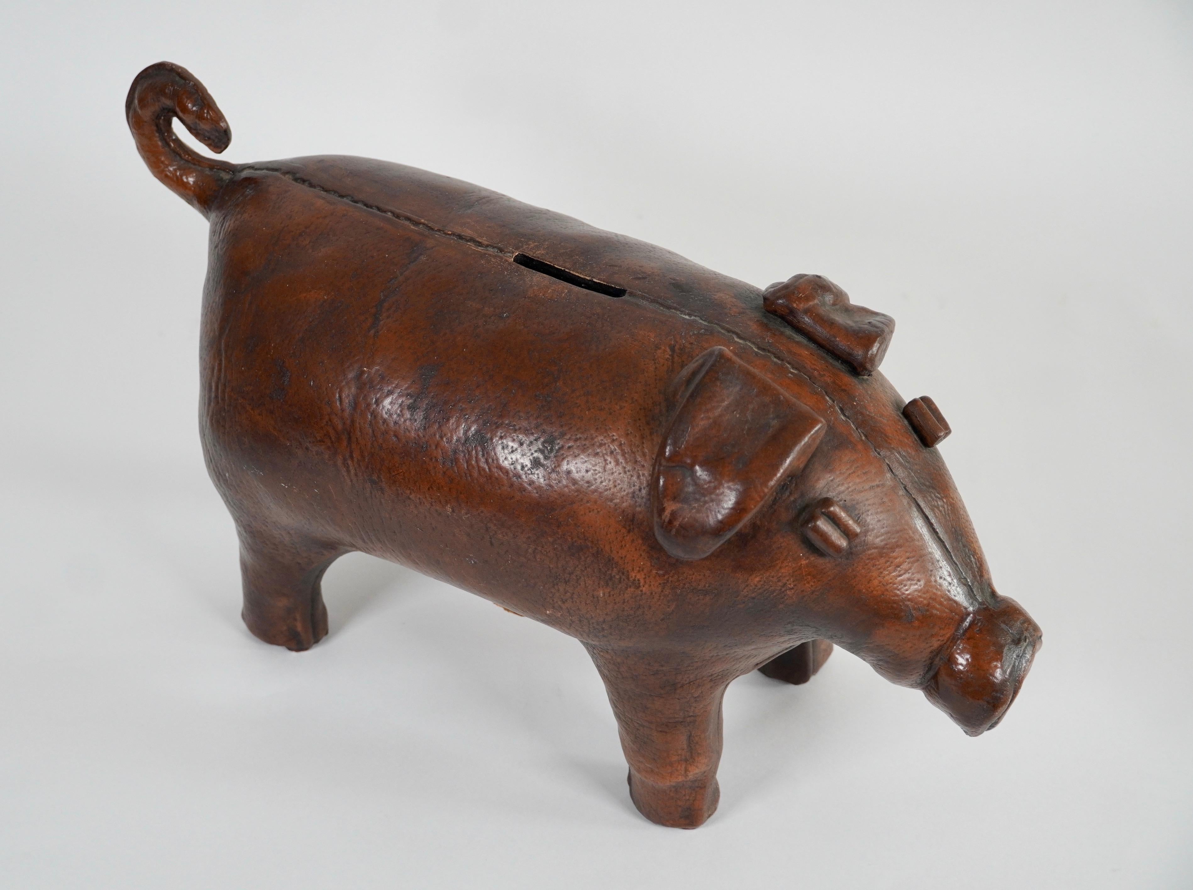A very unusual Piggy Bank, it being an exact copy of the Omersa leather pig foot rest, but this is a coin bank in ceramic with a slot on the back of the pig for the coins and a cork stopper underneath on its belly to retrieve them. The coloration,