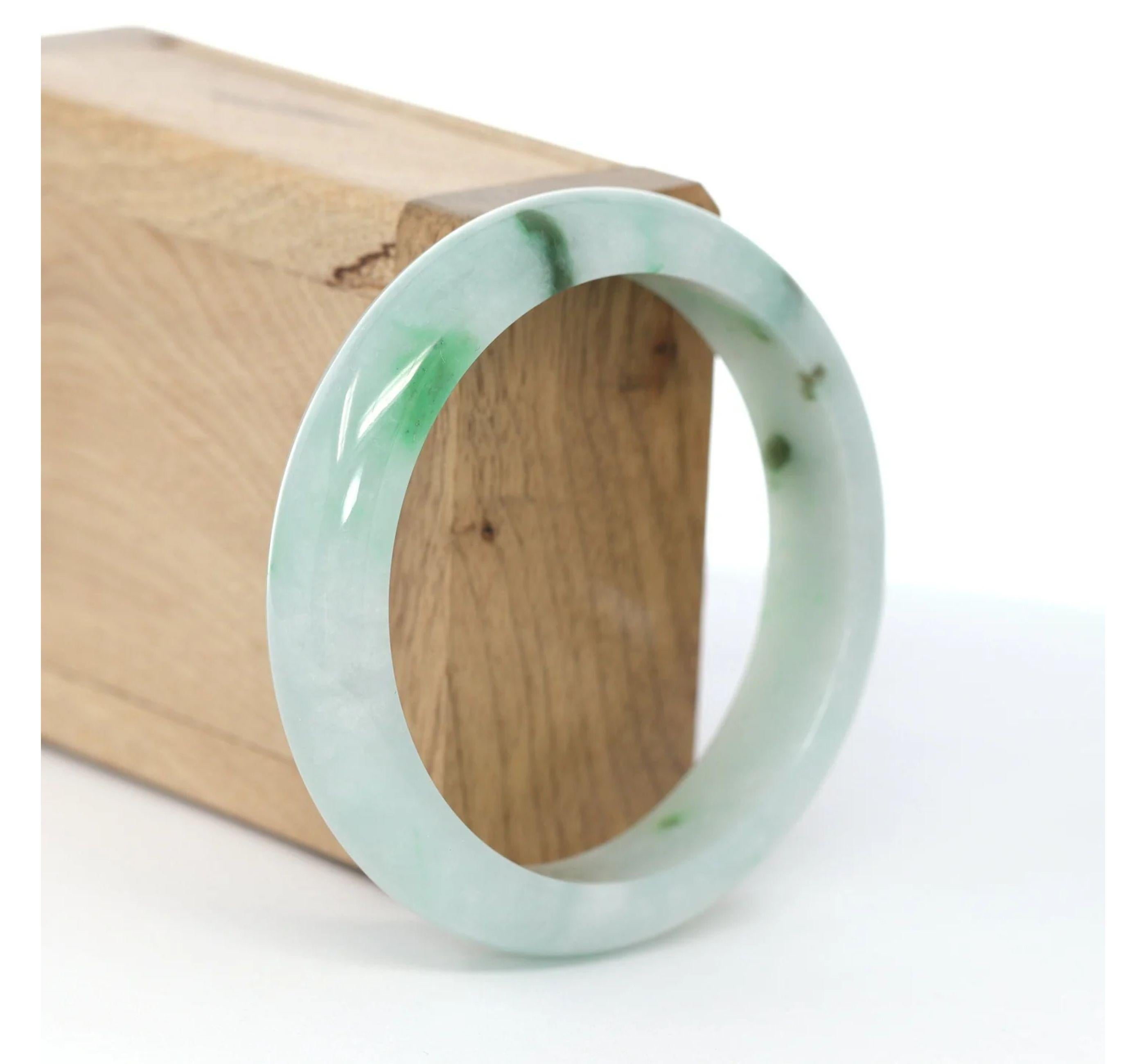 * DETAILS--- This Natural Burmese Jadeite Jade bangle is a beautiful green bangle. The texture is very smooth and clean even throughout the bangle, very beautifully translucent under the light. This bangle is characterized by beautiful green and