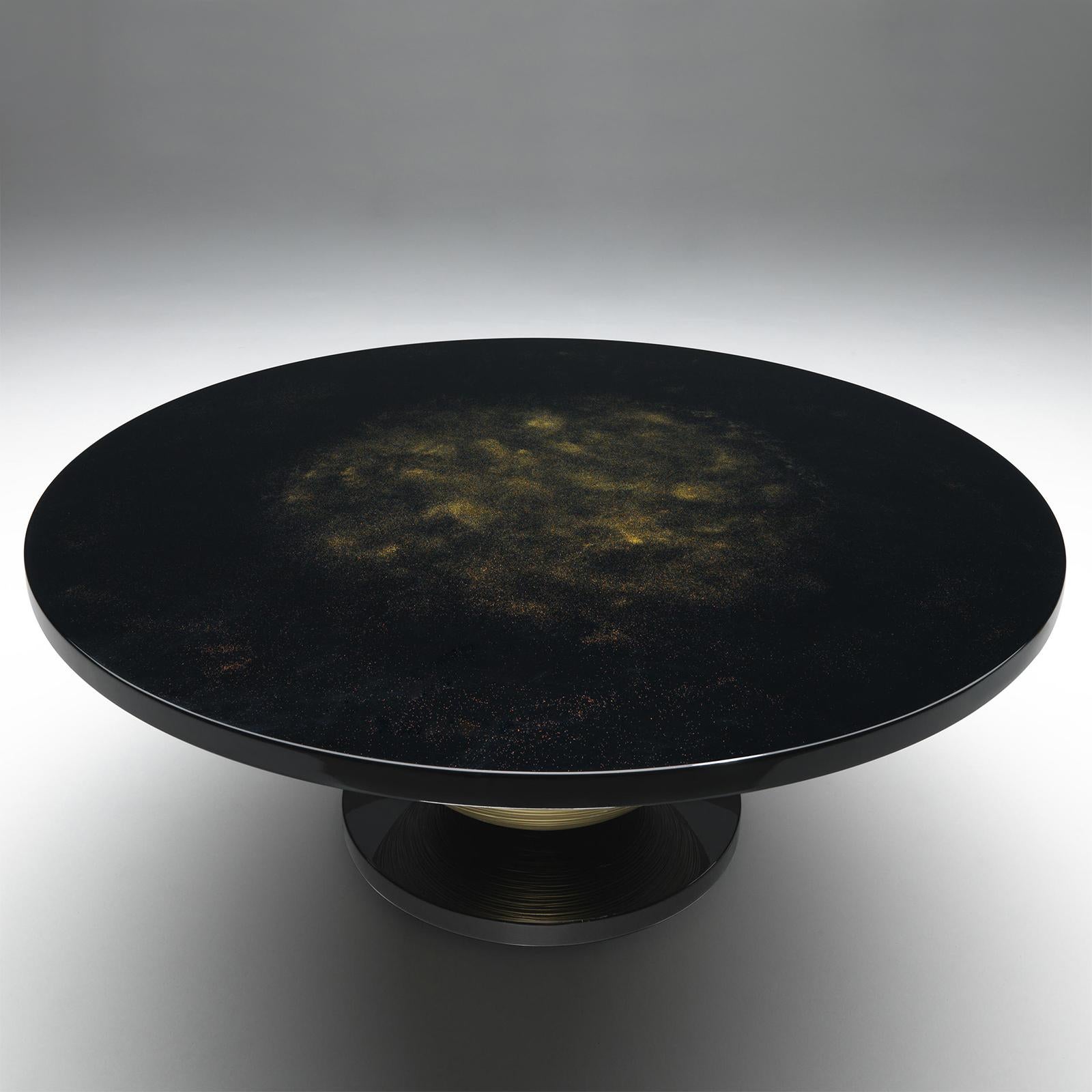 Dining Table Realm Dining with wooden table top in black lacquered finish
including golded pattern. With casted aluminum sphere base with striped
pattern painted in gold in matte finish. With round wooden pedestal in black
lacquered finish.
Also
