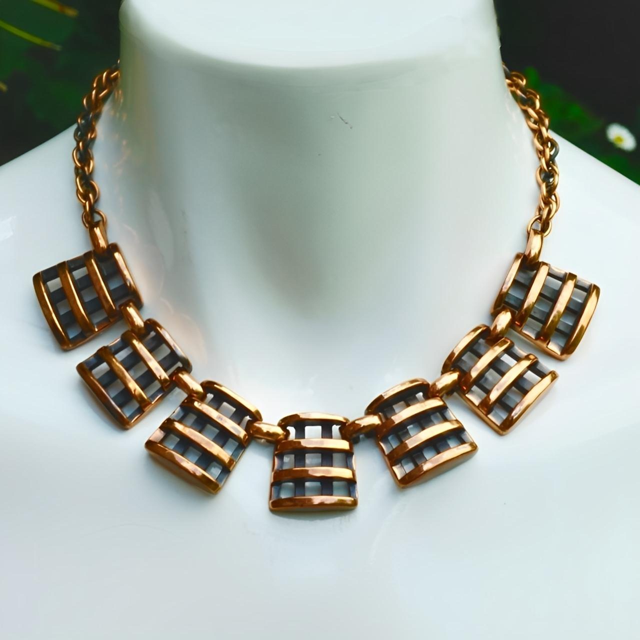 Wonderful Rebajes anodized copper mid century necklace, featuring a wonderful seven link abstract polished design, with a Prince of Wales chain.

Measuring length 40 cm / 15.75 inches by width 2.2 cm / .86 inches. The signed fold over clasp works