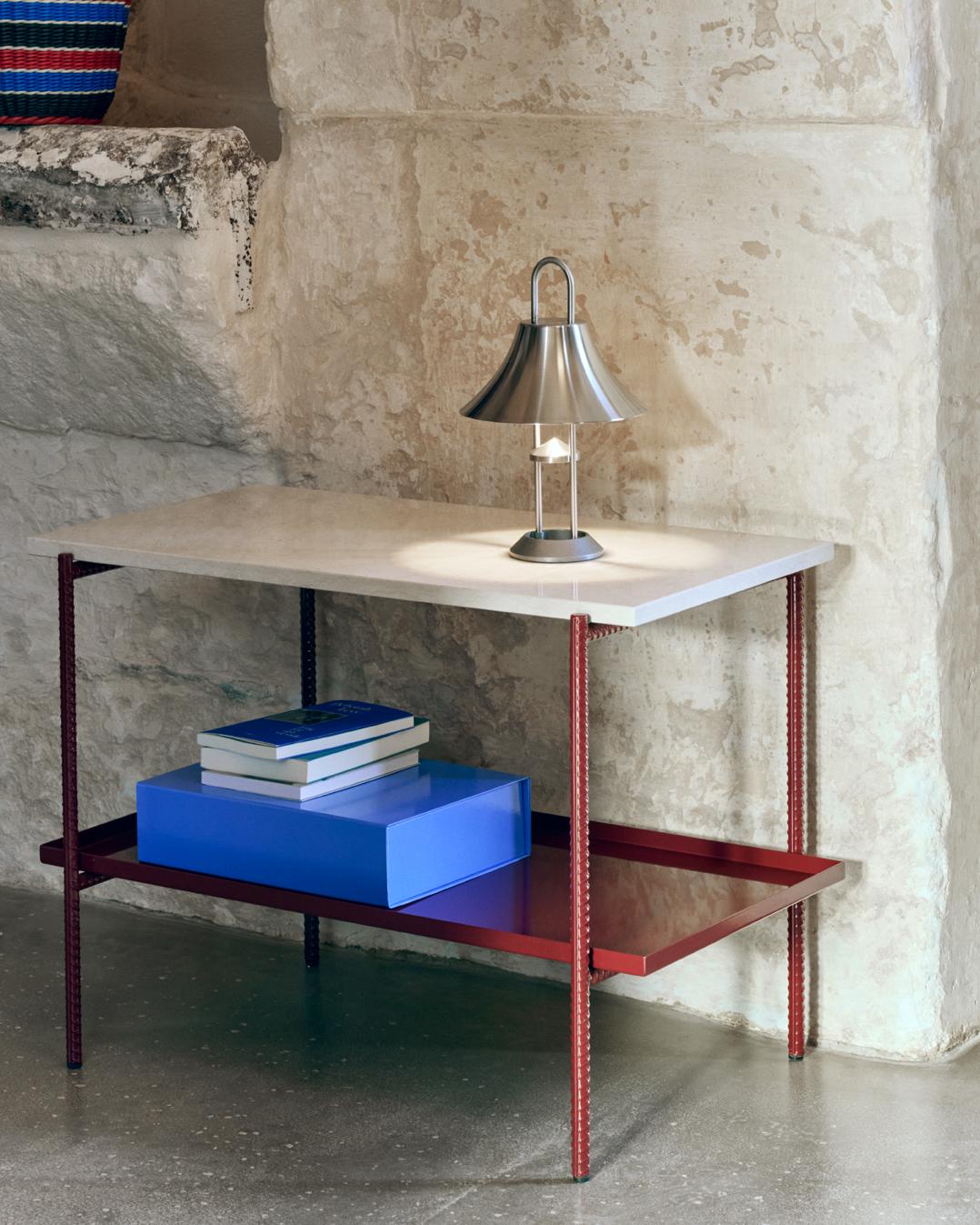 Sylvain Willenz’s Rebar tray table having a design that juxtaposes the reinforced steel bar frame with black marble tops and metal trays to create a balanced aesthetic. The table is suitable for using in private, corporate or public