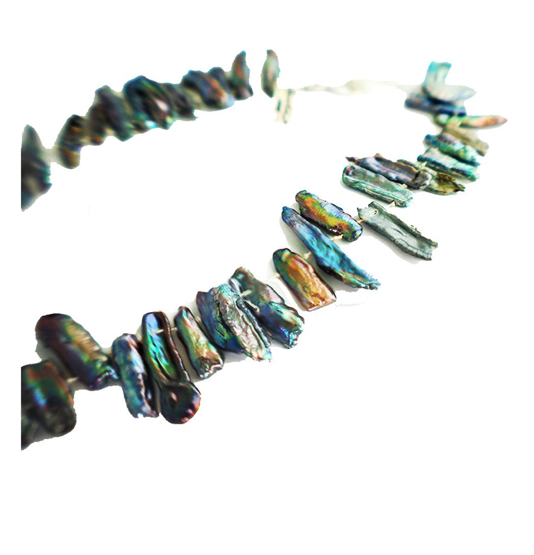 Abalone is a gastropod shellfish which has an ear-shaped shell and producing these elongated shells are rare.

(60) varying  lengths up to 1-1/4 inches in length are strung on silk and knotted to separate each shell.  
An array of shapes and colors
