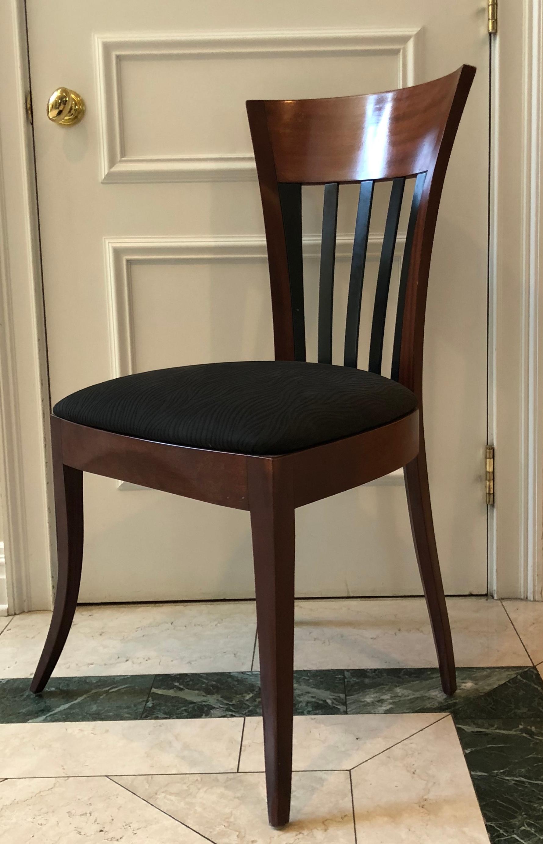 A set of 7 slat-back Rebecca chairs by Adam Tihany for Pace collection in mahogany with ebony slatted backs. The seats are upholstered in a matte black material.