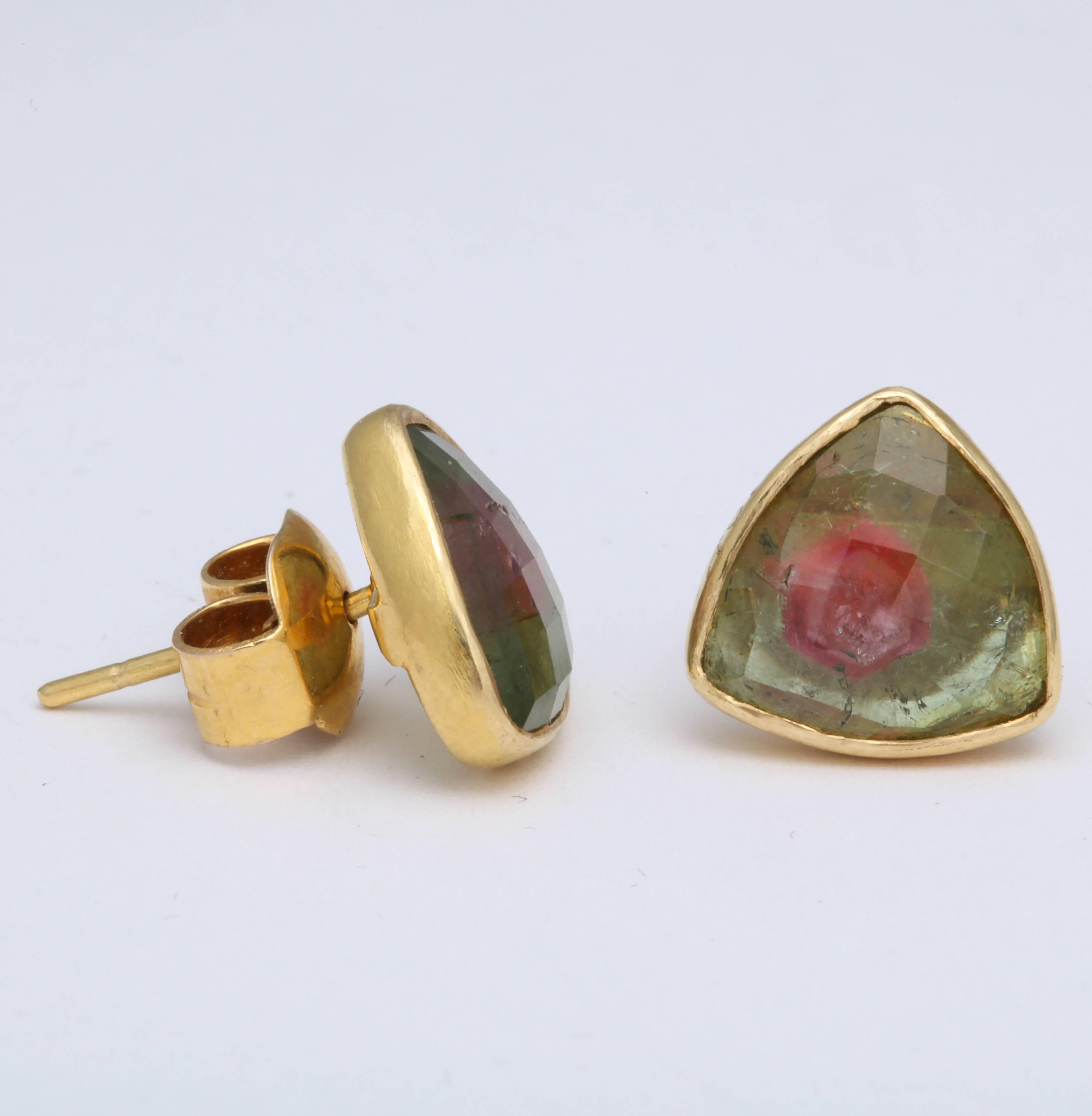 A pair of faceted watermelon tourmaline triangle stud earrings. The stones have been bezel set in 18kt yellow gold.

Height: .50 inch