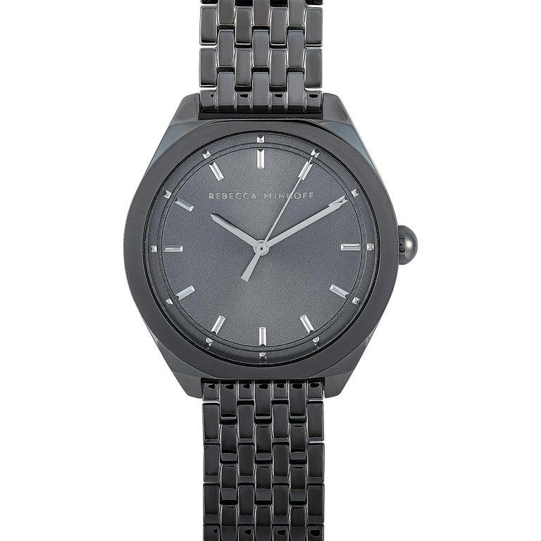 This is the Rebecca Minkoff Amari, reference number 2200328. The watch is presented with a gunmetal gray ion-plated stainless steel case that measures 38 mm in diameter. The case is water-resistant to 30 meters and mounted onto a matching gunmetal